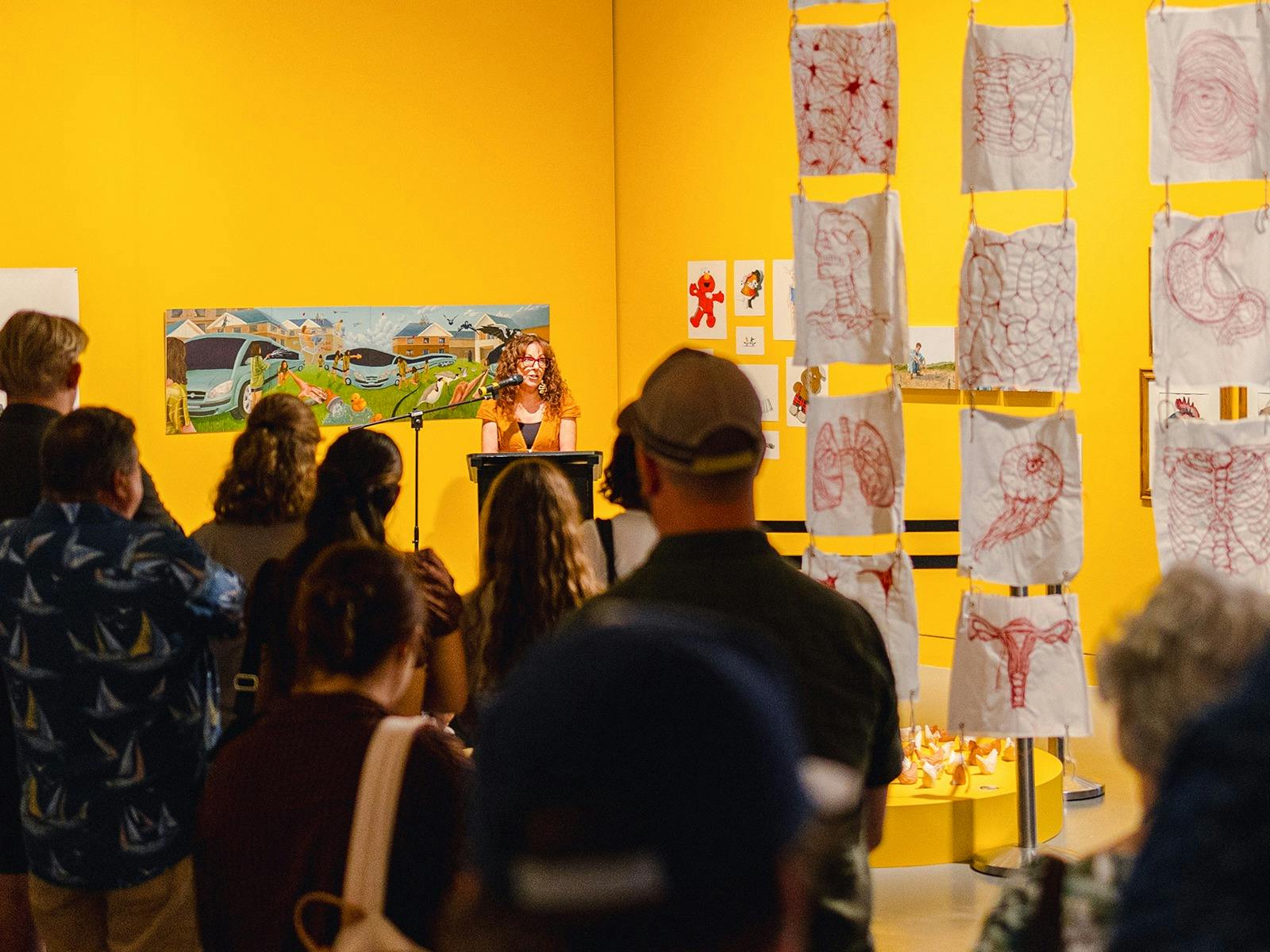 Audience viewing opening speech at First Class Art exhibition