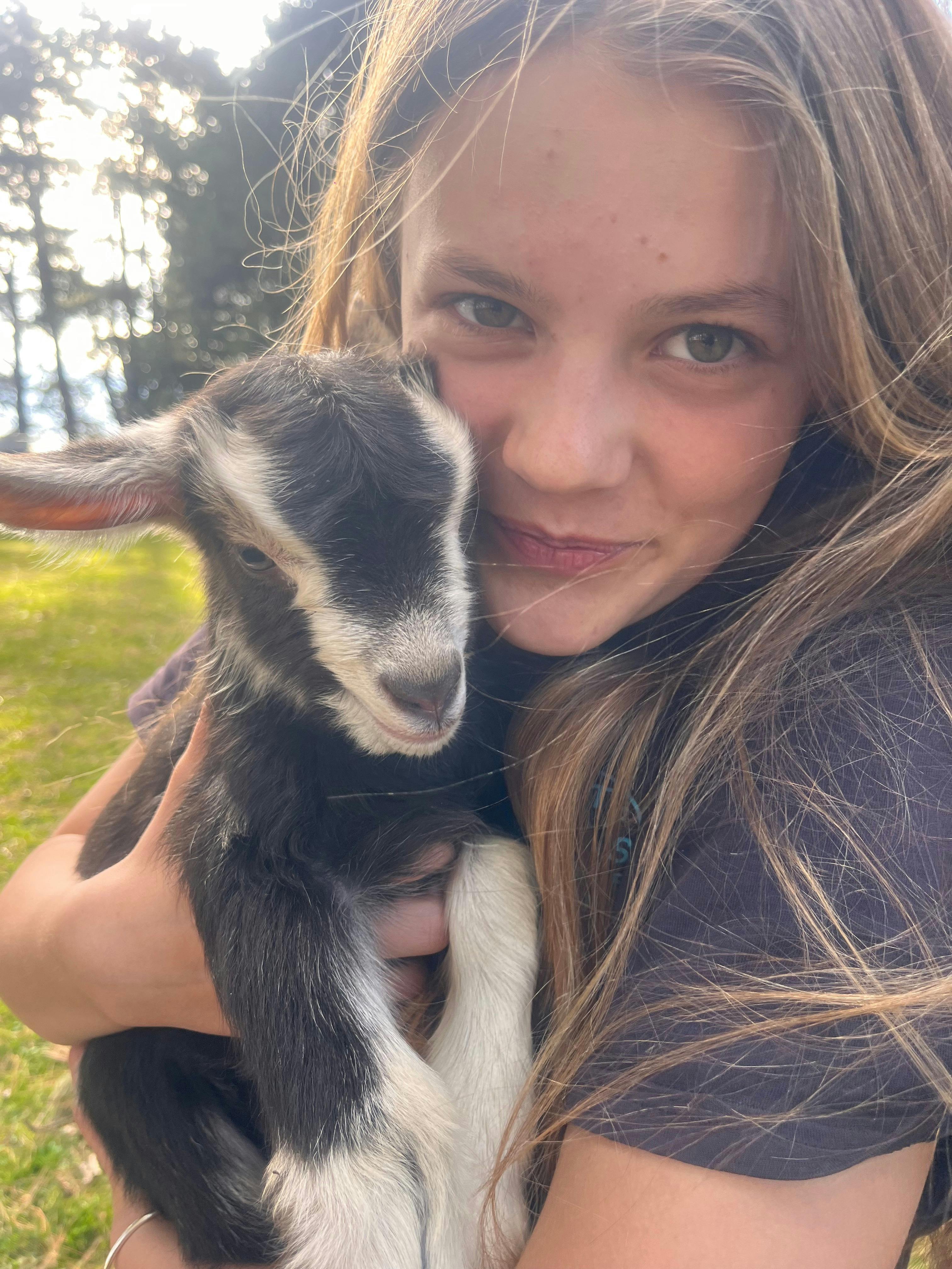 girl holding a goat