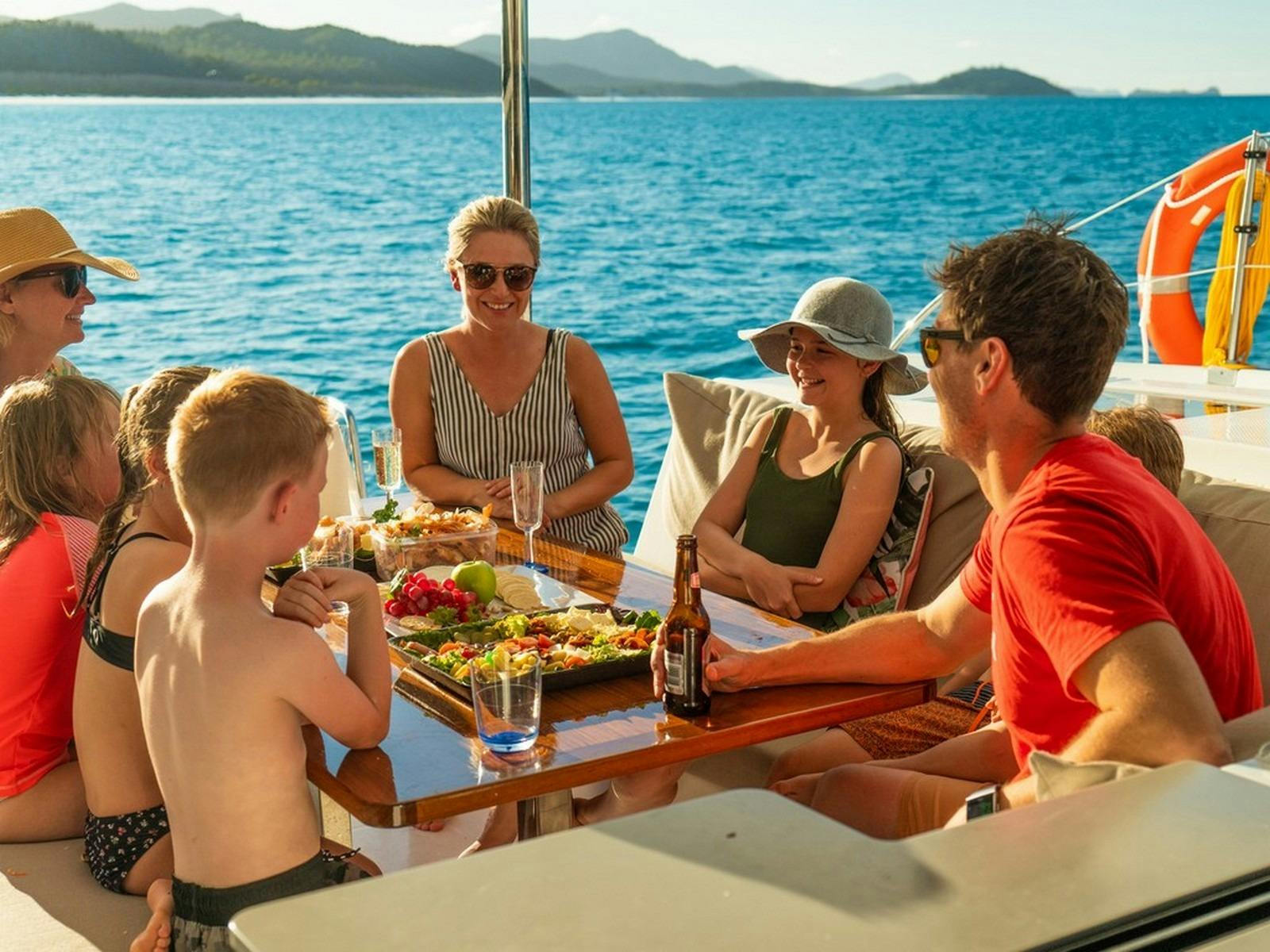 People sitting on the back deck of a boat