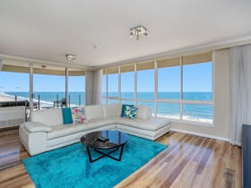 Open plan living and dining area with beachfront views
