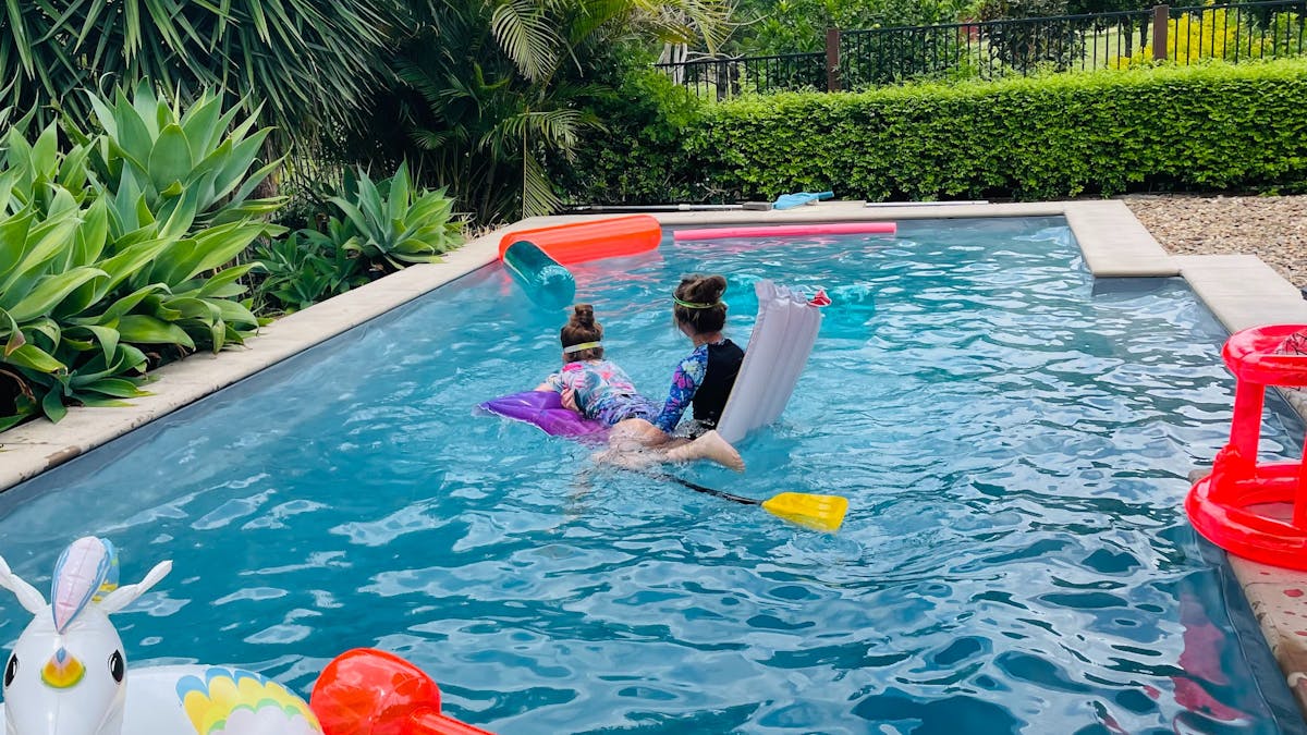Brumbies Hollow Pool featuring children playing with pool toys Brumbies Hollow Pool featuring children playing with pool toys