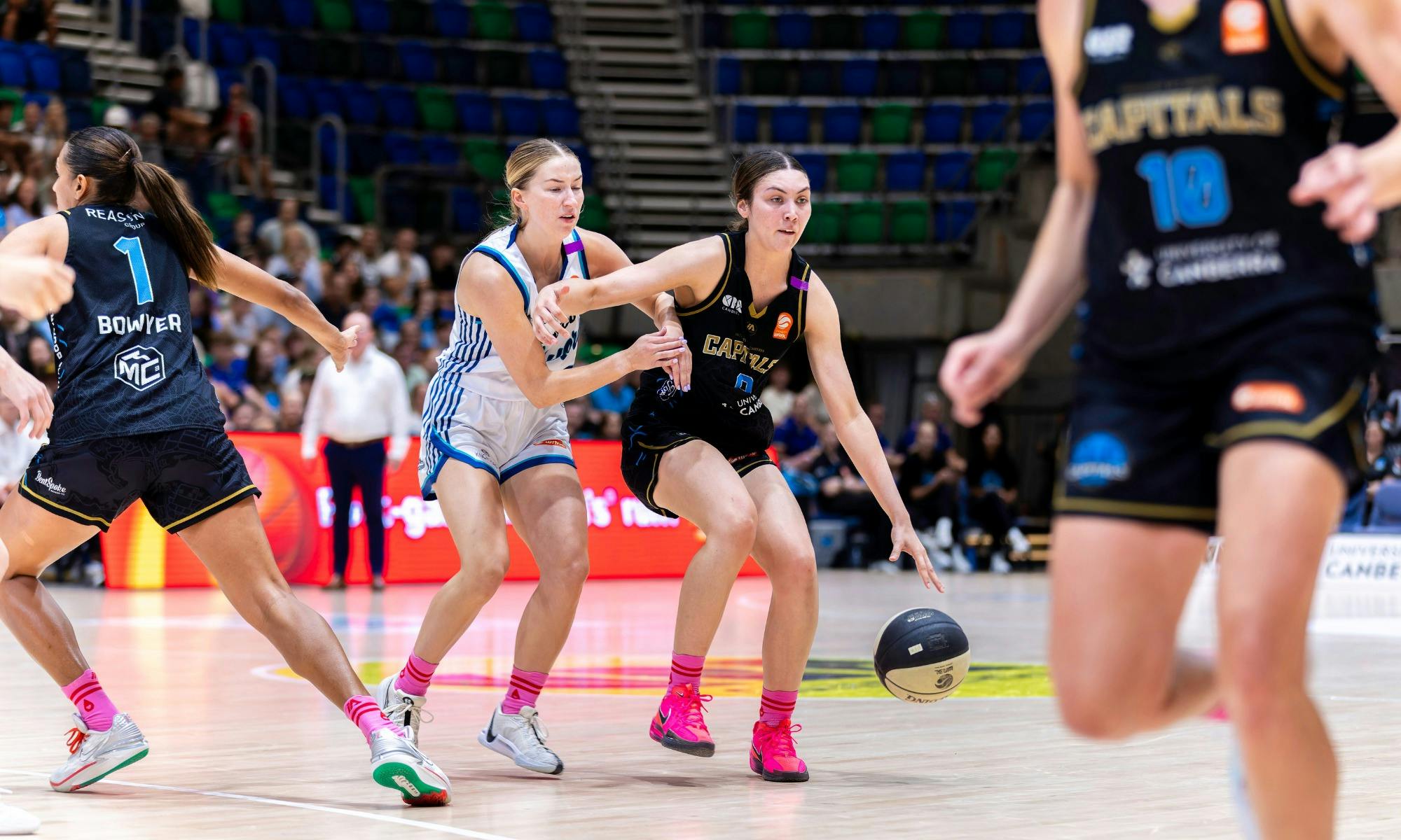 UC Capitals player driving to the basket for a layup during a WNBL game.
