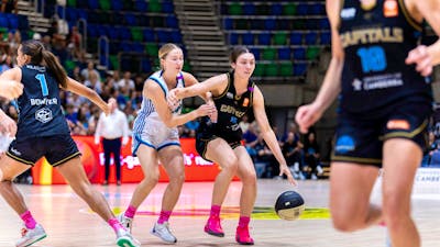 UC Capitals player driving to the basket for a layup during a WNBL game.