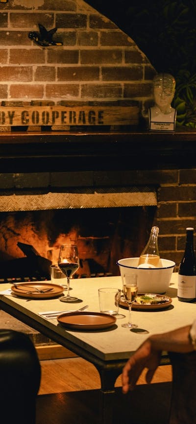 Eating in front of the open wood fire in a private dinnig and functions space at the Steampacket Hot