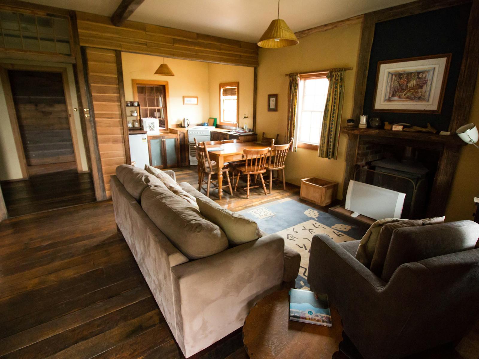 the lounge room and kitchen of sweetcorn cottage which sleeps 7 people