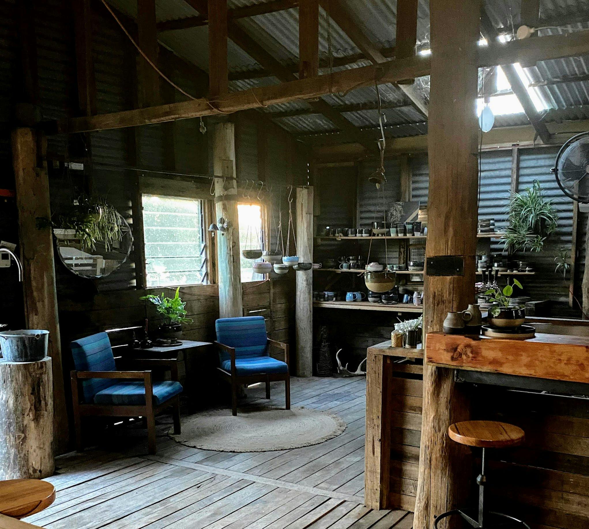 Shop with seating and shelves of ceramics