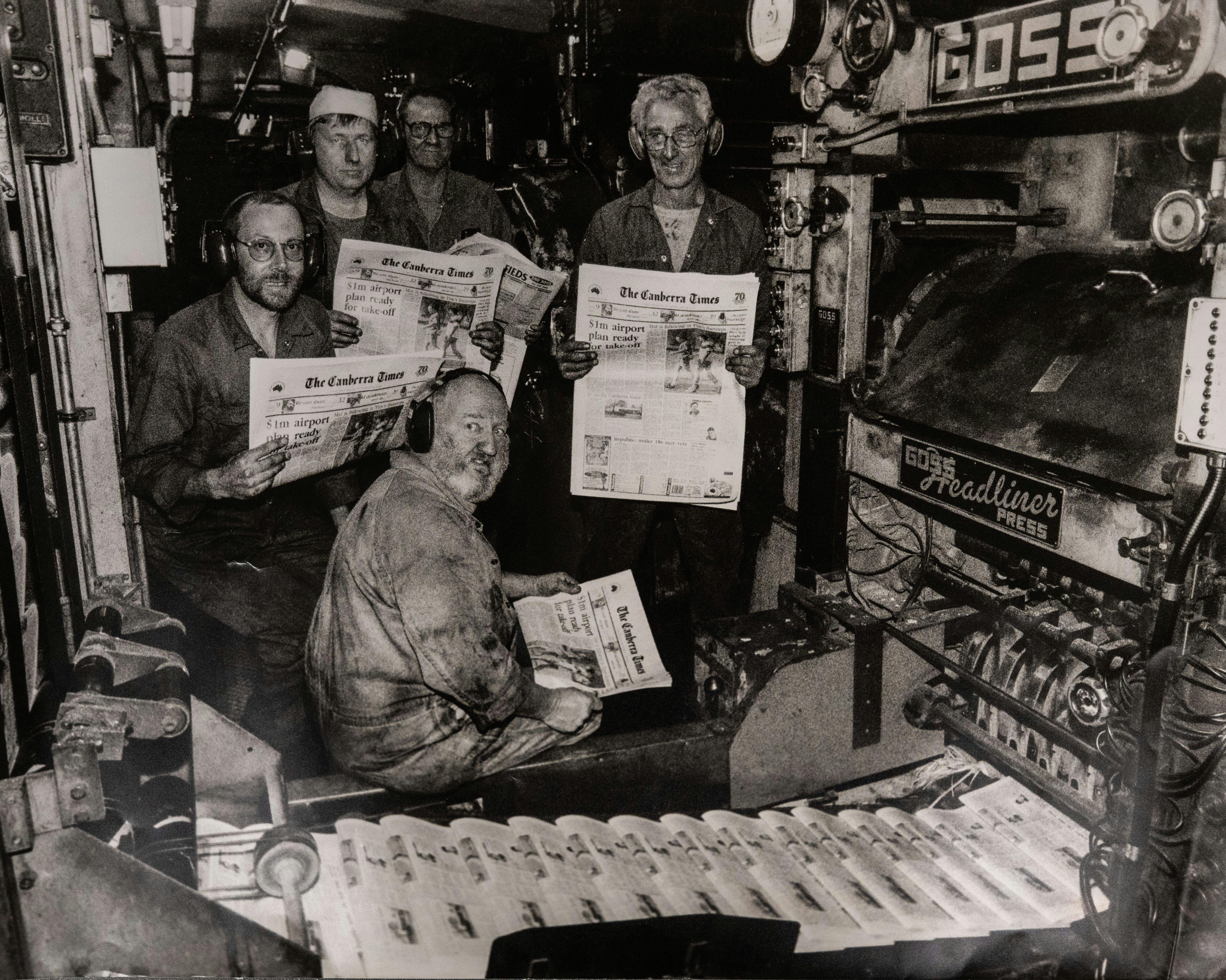 1996 Canberra Times printing press with workers holding copies of the newspaper