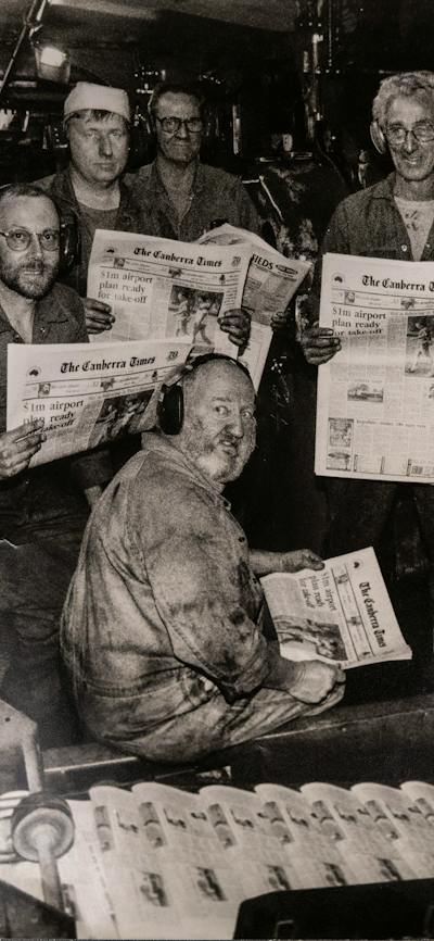 1996 Canberra Times printing press with workers holding copies of the newspaper