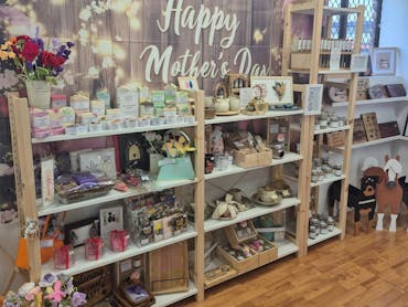 A vibrant Mother’s Day retail display filled with handcrafted items