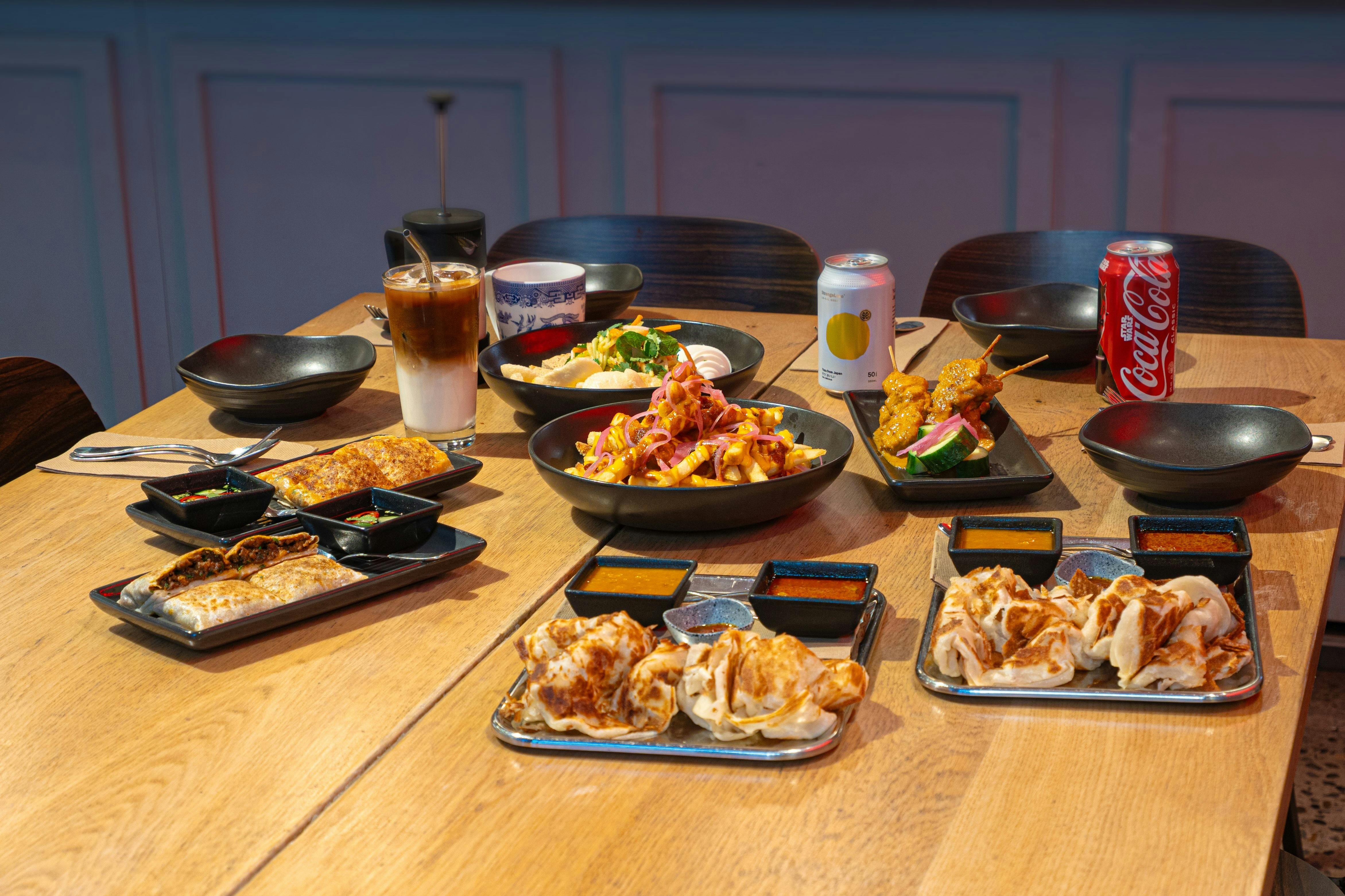 Roti canai, chicken satay, Thai beef madtarbak, rojak salad and loaded fries