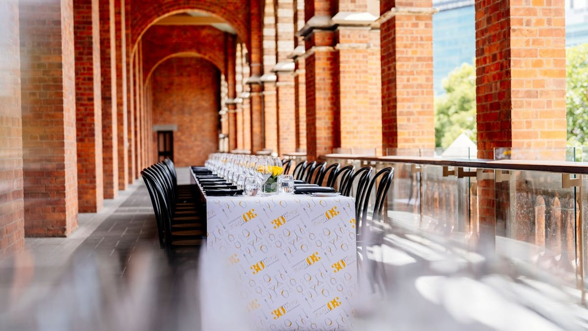 Long table set up on a balcony at The Old Museum