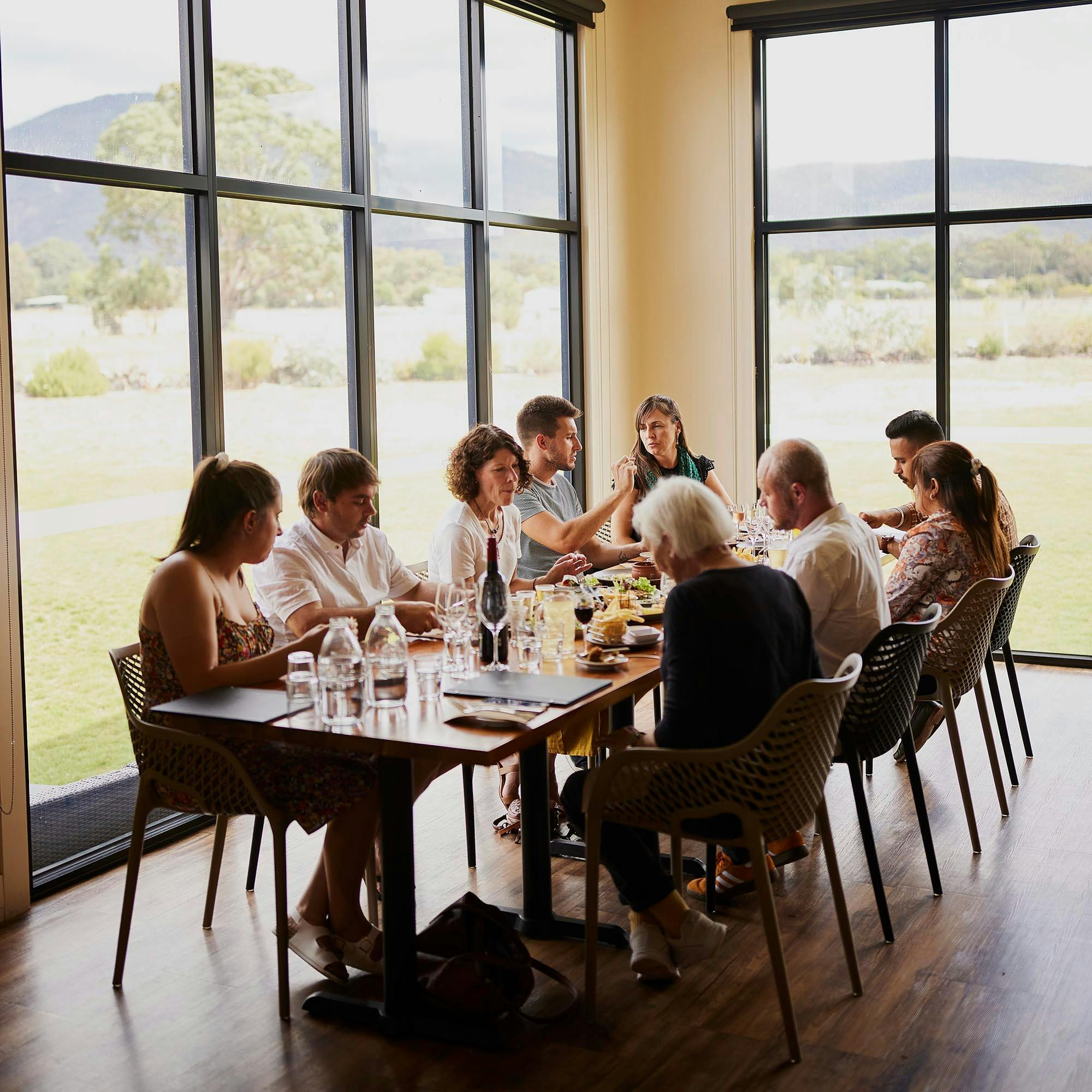 Group of people dining at Pomonal Estate restaurant with a view