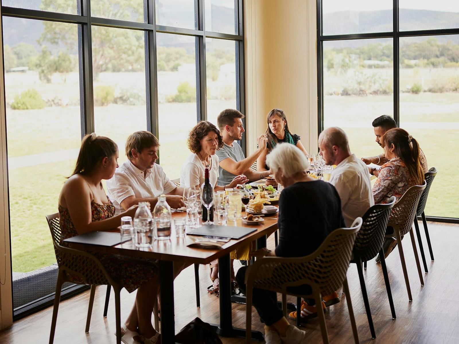 Group of people dining at Pomonal Estate restaurant with a view