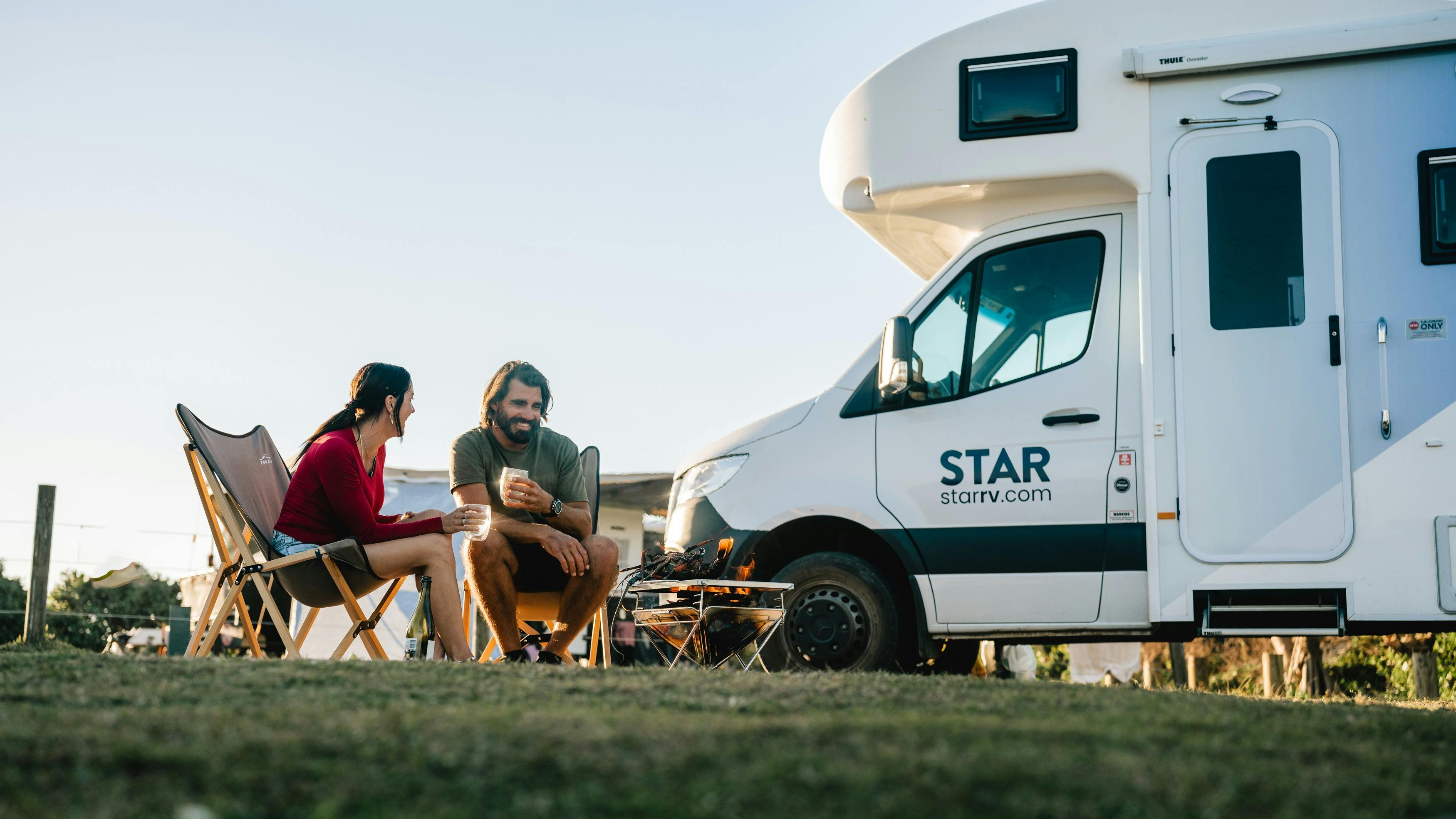Couple enjoying a picnic by Star RV motorhome
