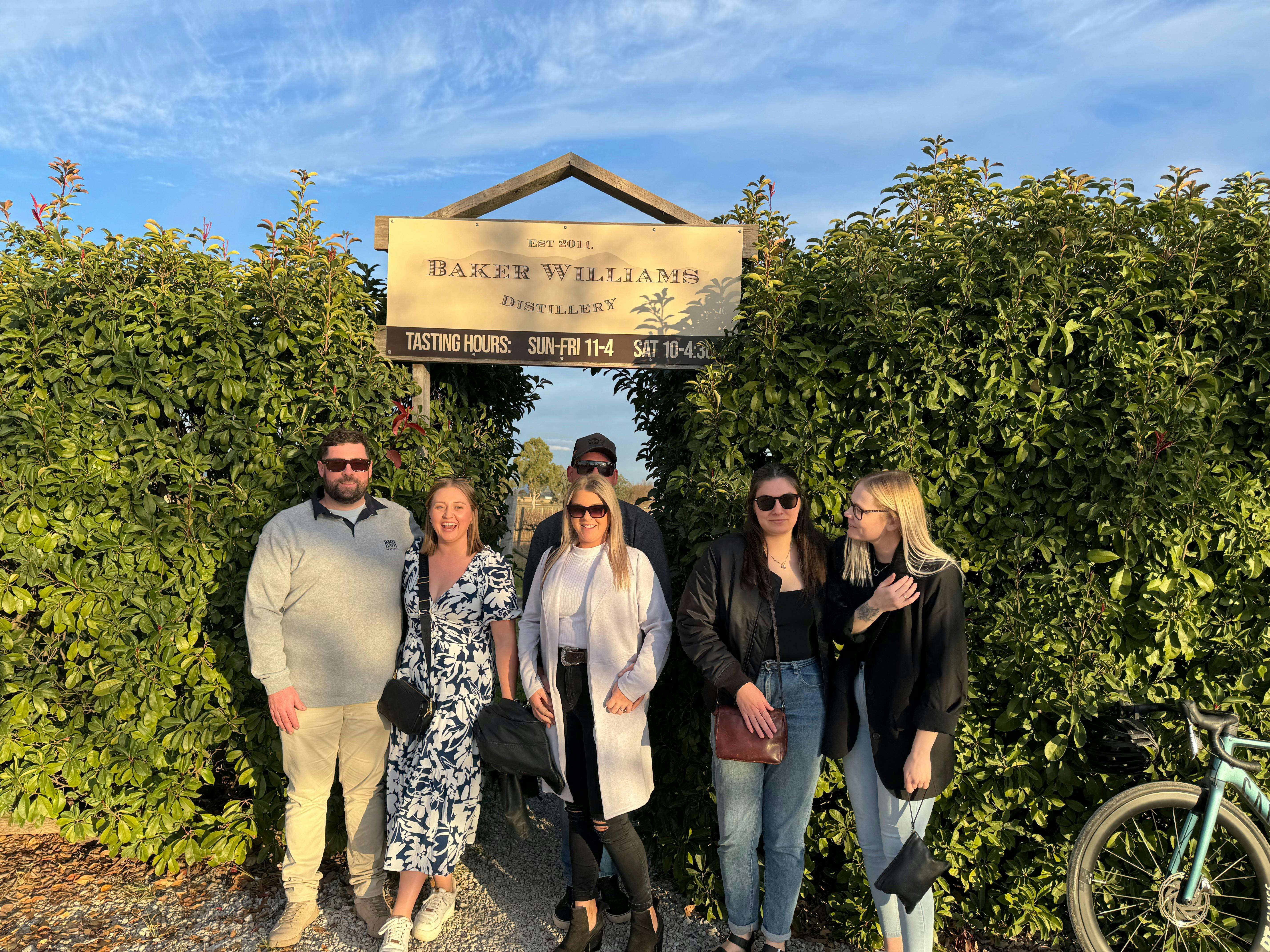 Mudgee Ale trail customers standing in front of a distillery sign