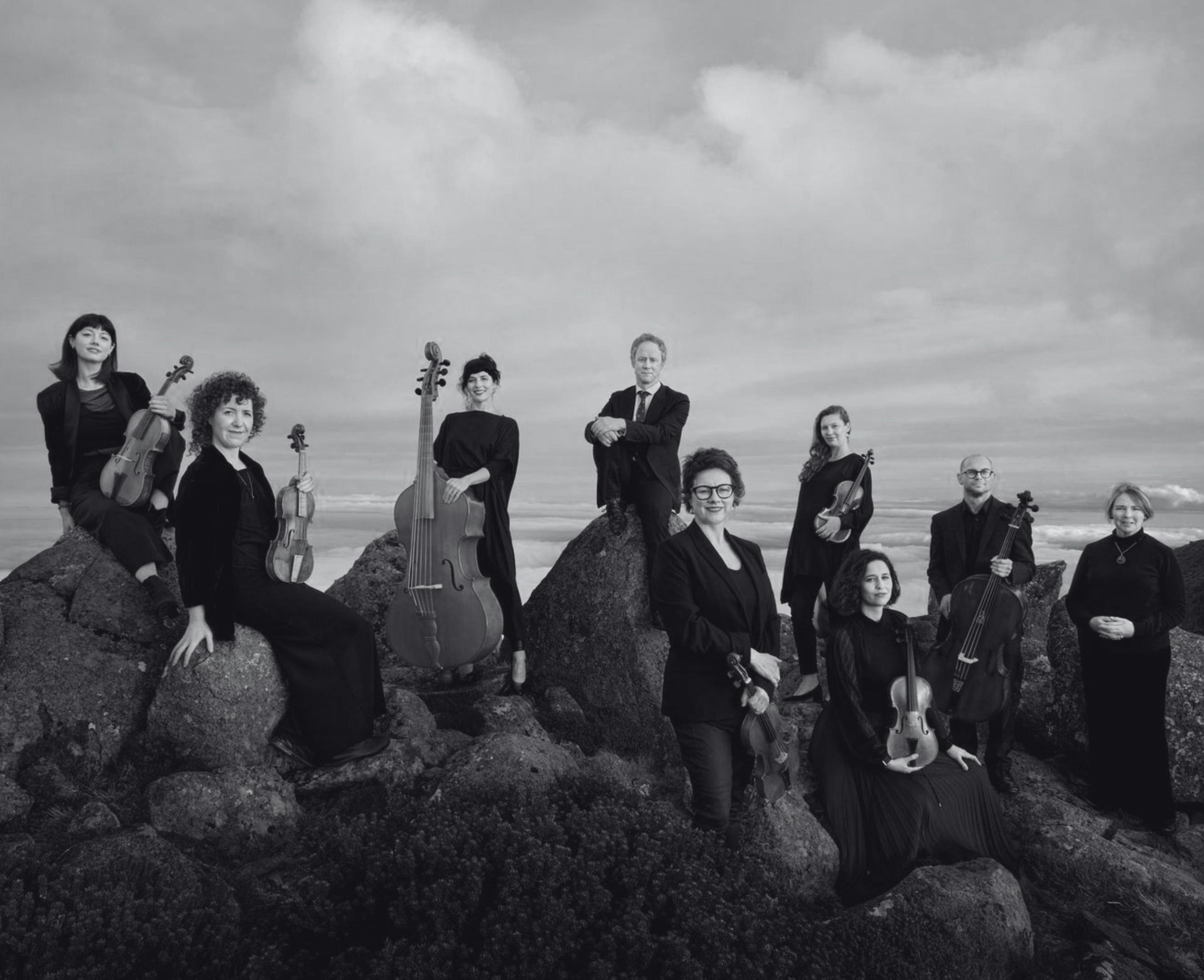 Several musicians pose with their instruments
