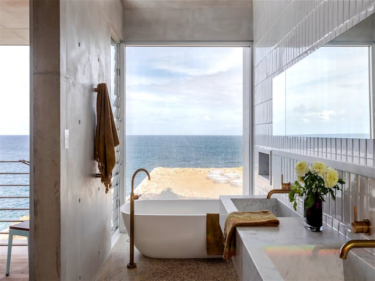 Soothing bathtub with panoramic ocean views and crashing waves