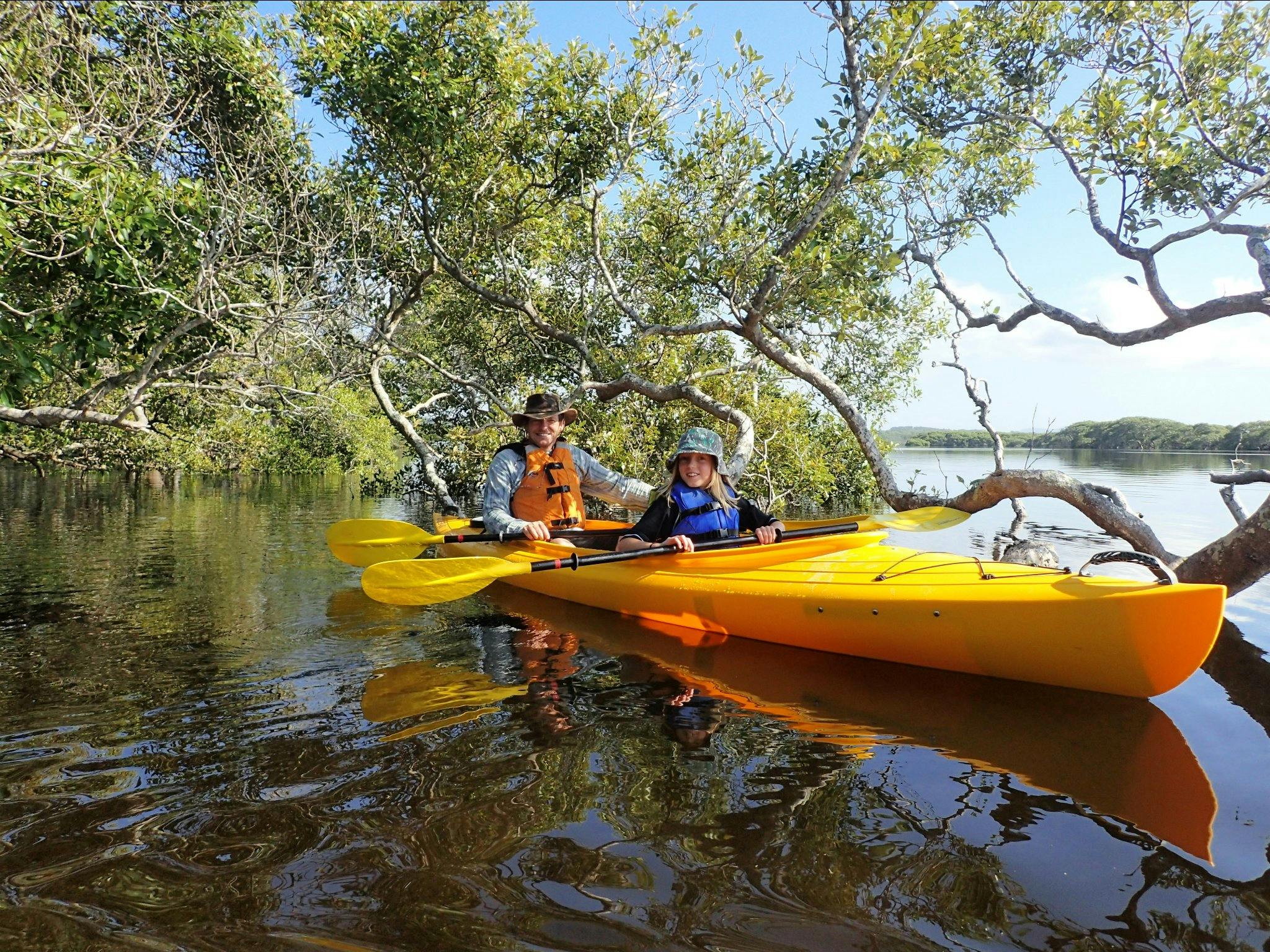 Father and son enjoying paddling in the mangroves