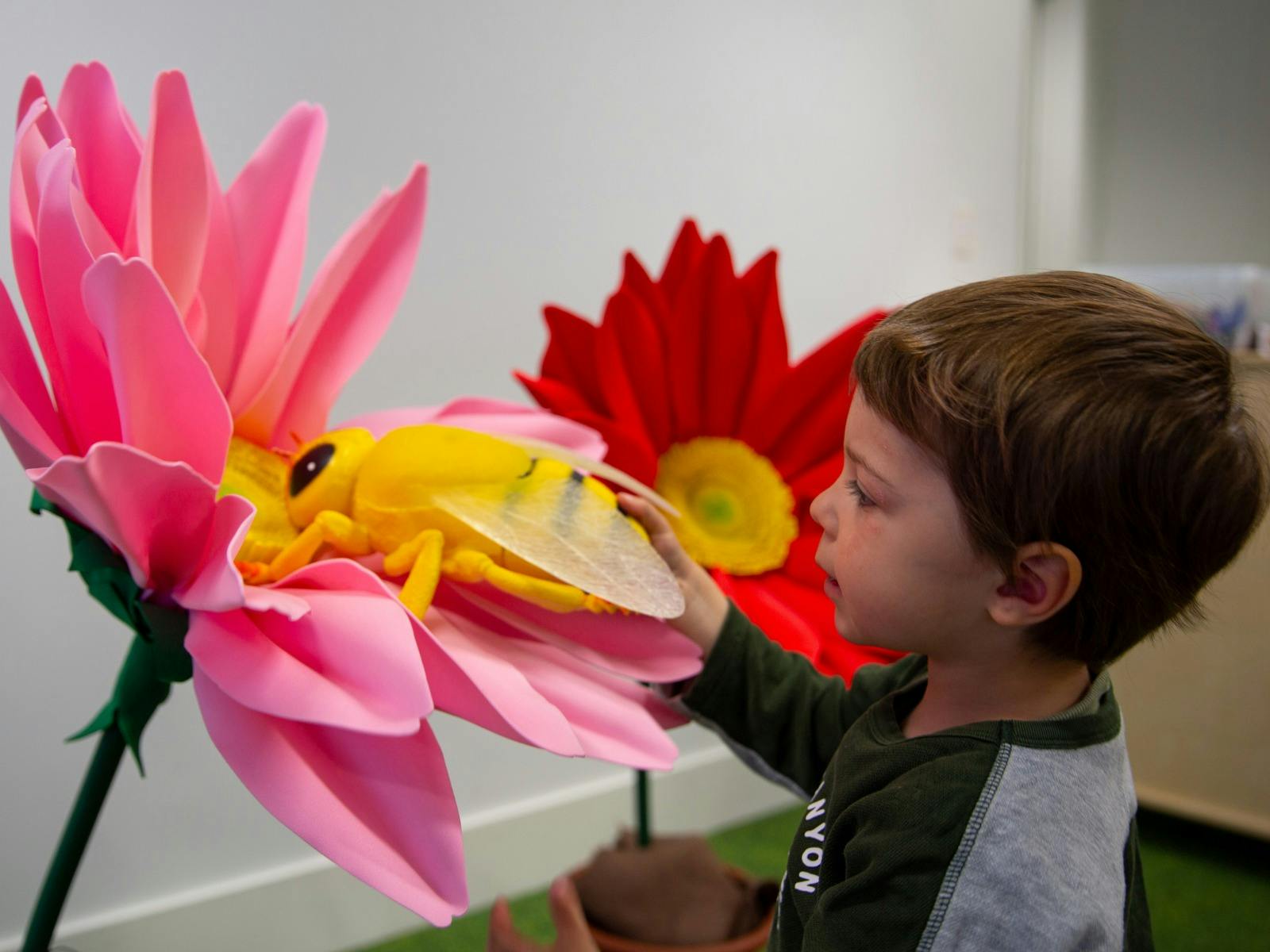 A child explores flowers at Science Time: Spring