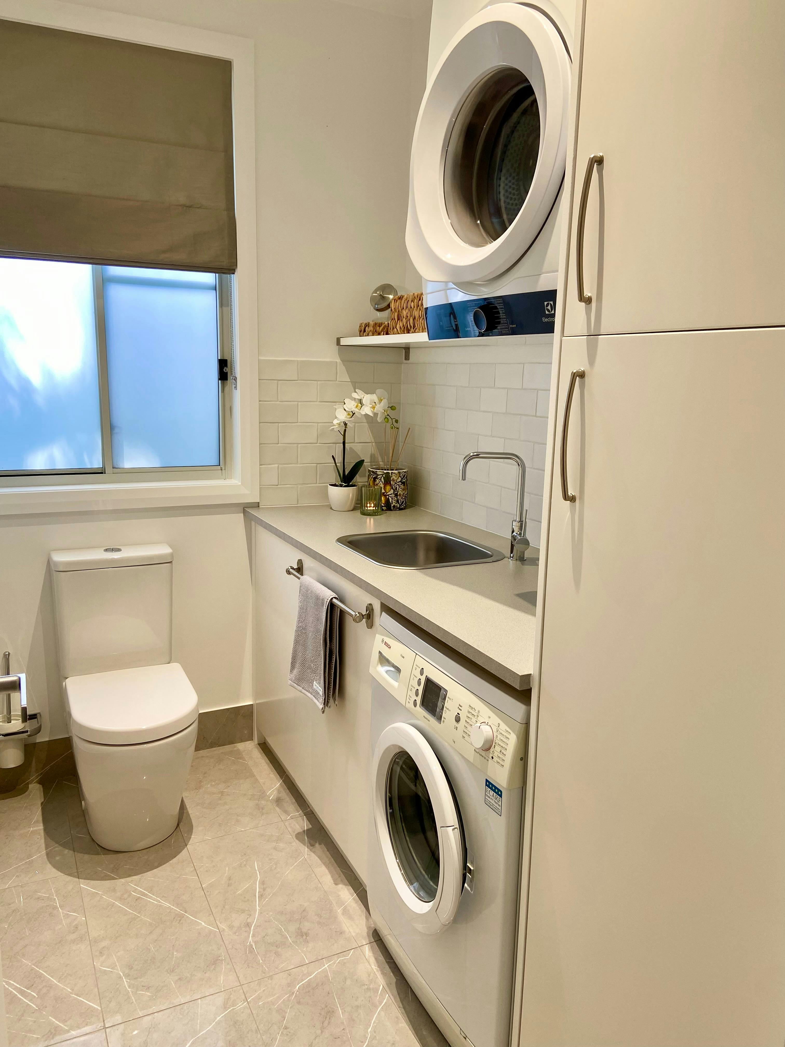 The laundry/powder room has a washer, dryer, iron, board, washing powder, fabric softener, pegs etc.