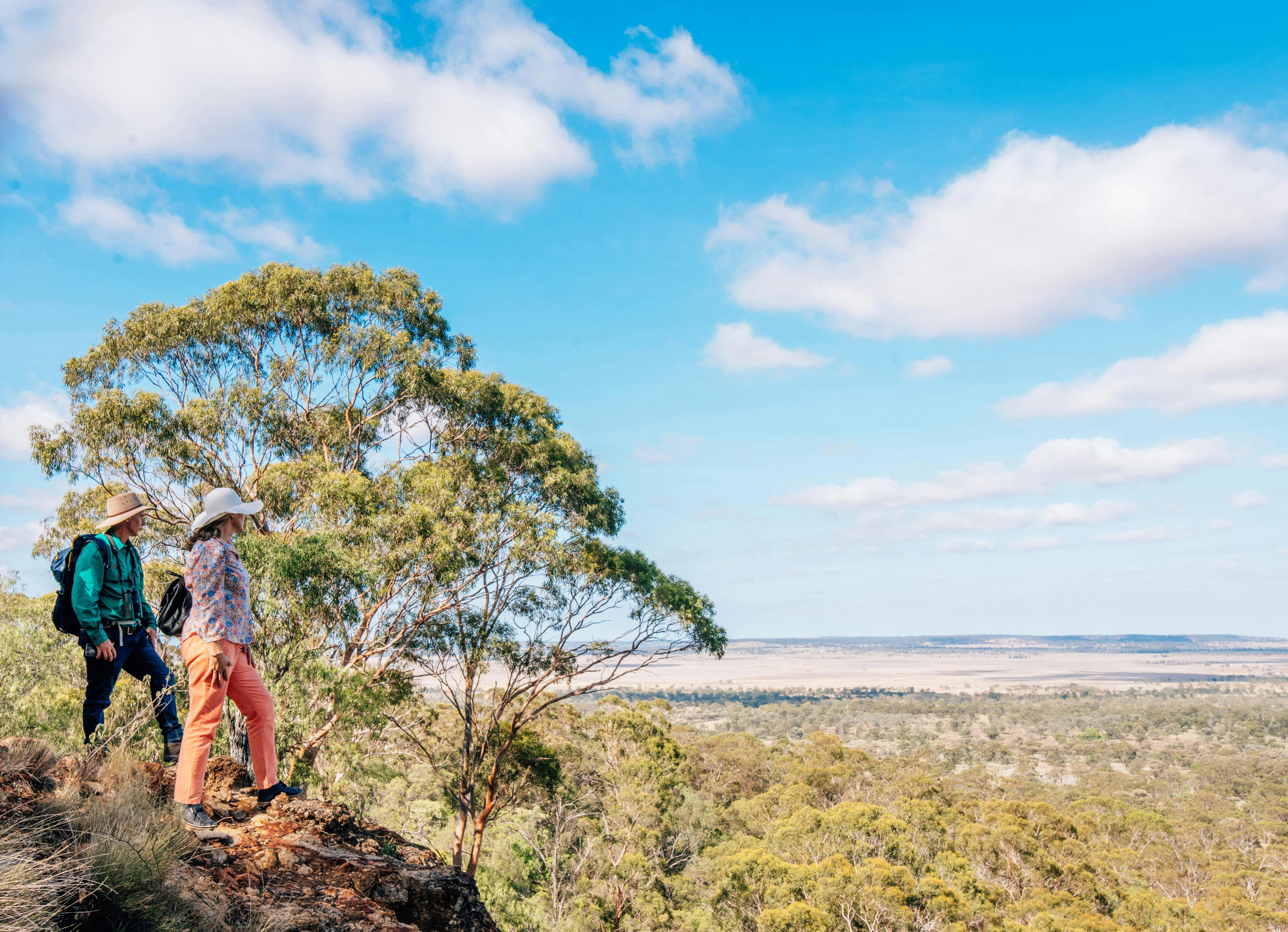 Two people looking out at the view from the top of Mt Abundance near Roma