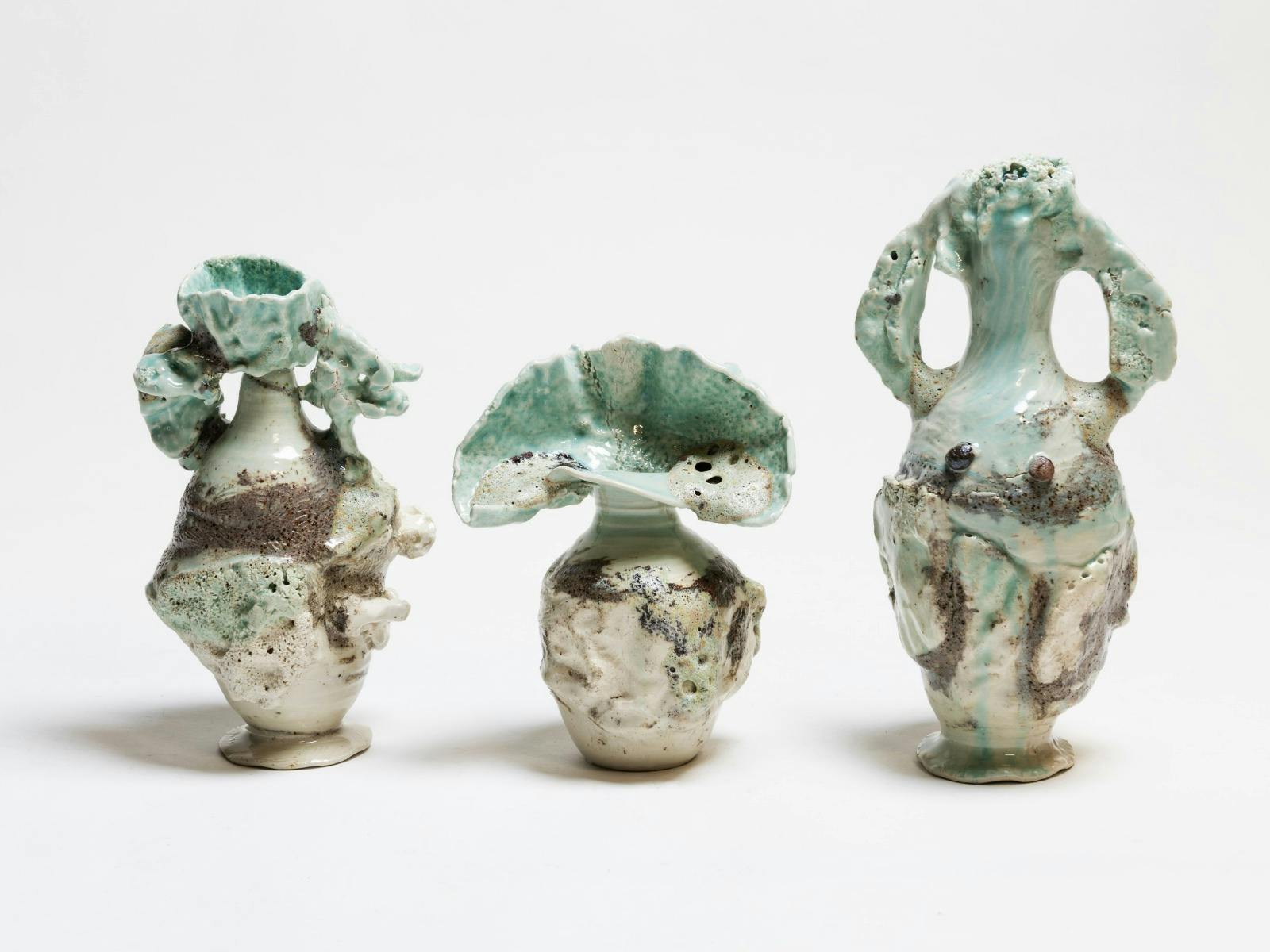 Three sculptural stoneware vessels with textured surfaces and sea-green glaze.
