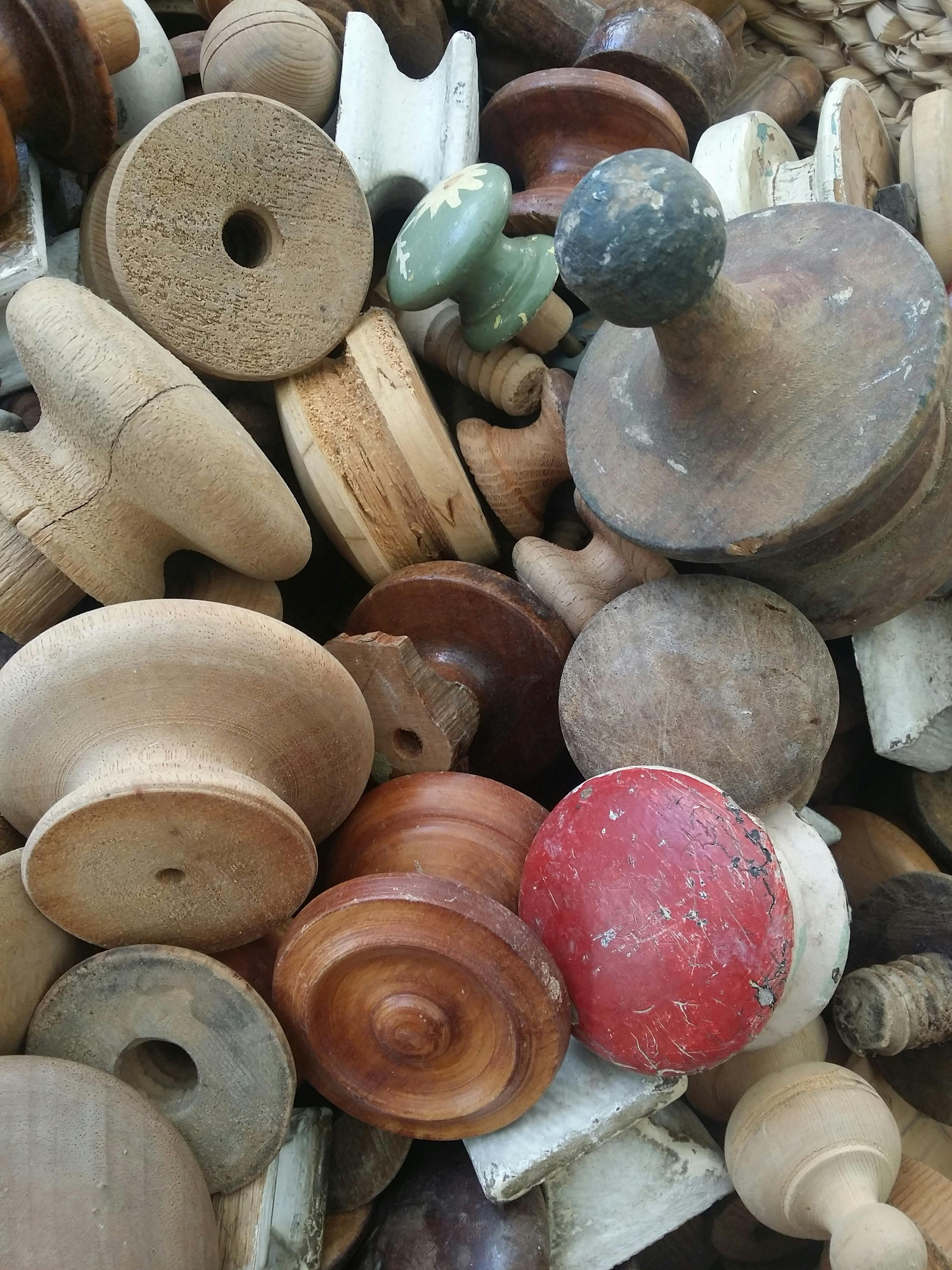 A collection of timber knobs from old chests of drawers