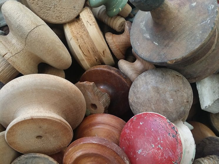 A collection of timber knobs from old chests of drawers