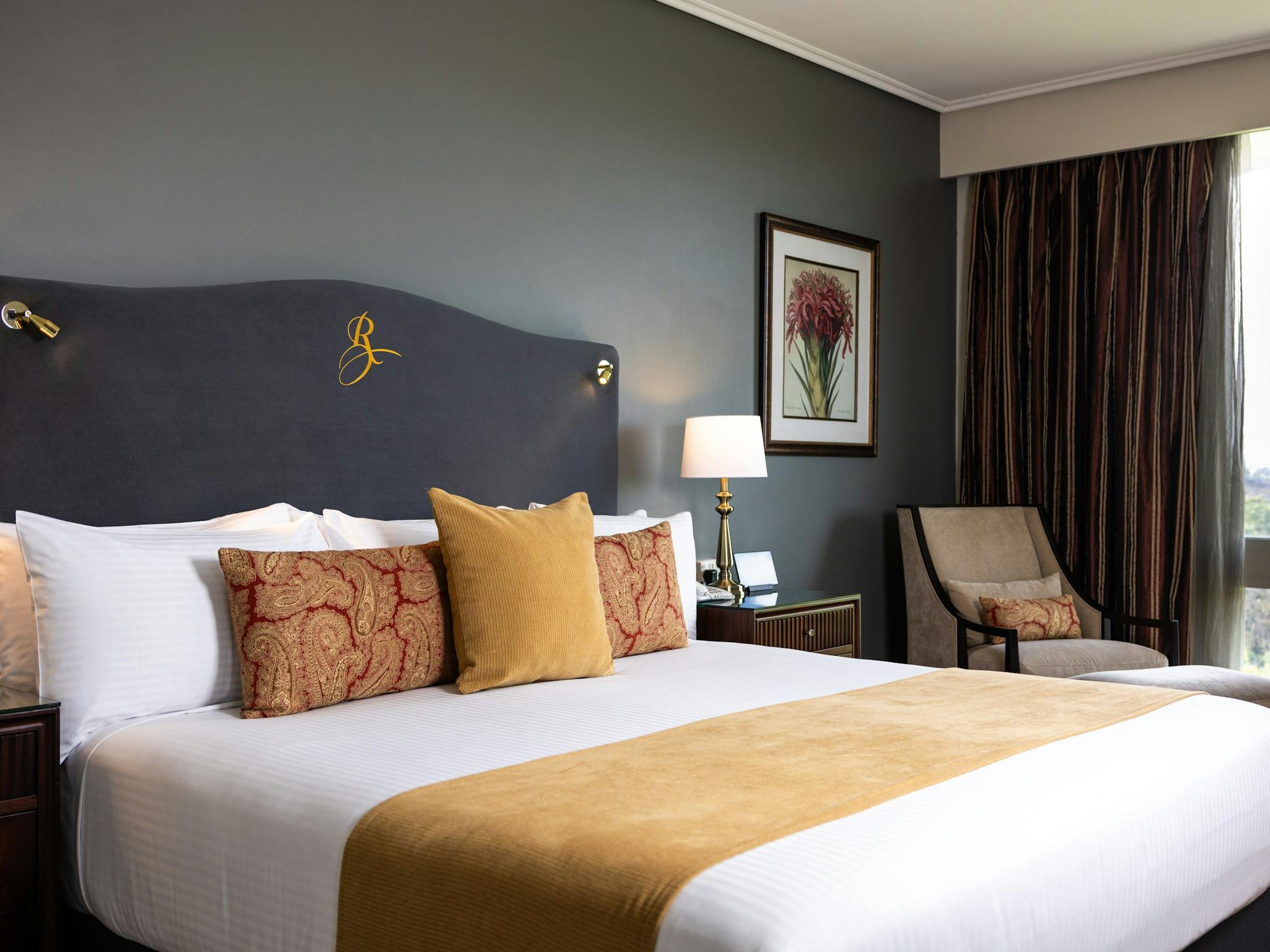 King bed with velvet headboard and suede chair, Executive Suite Royal on the Park Hotel Brisbane King bed with velvet headboard and suede chair, Executive Suite Royal on the Park Hotel Brisbane