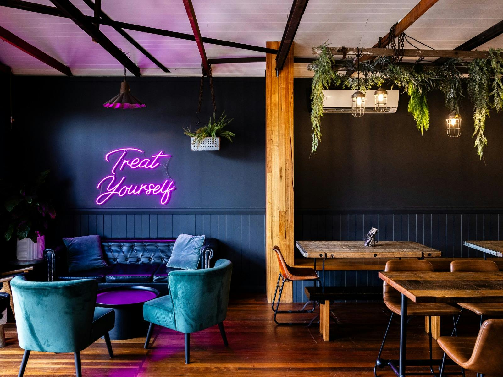 The Rutledge Bar & Eats lounge and neon sign "treat yourself"