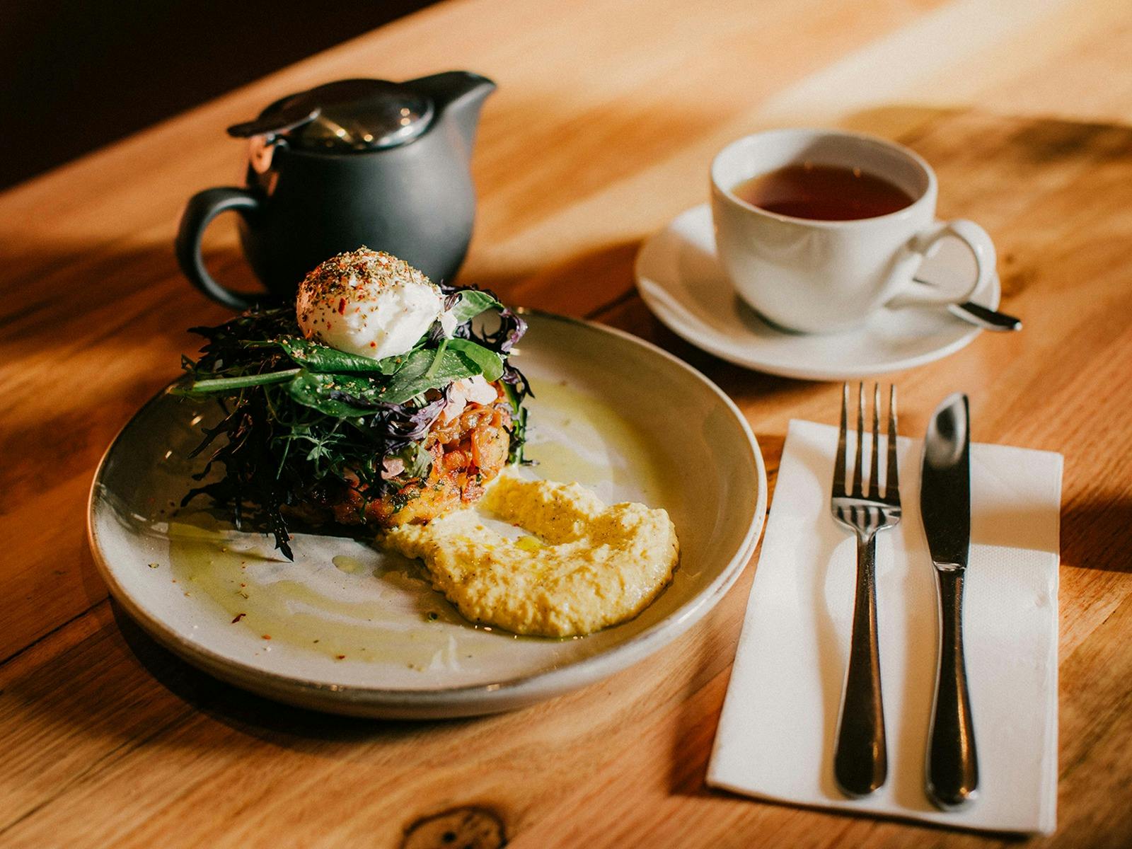 Potato Rösti with smoked salmon, poached egg, caramelised onion, corn puree and local greens