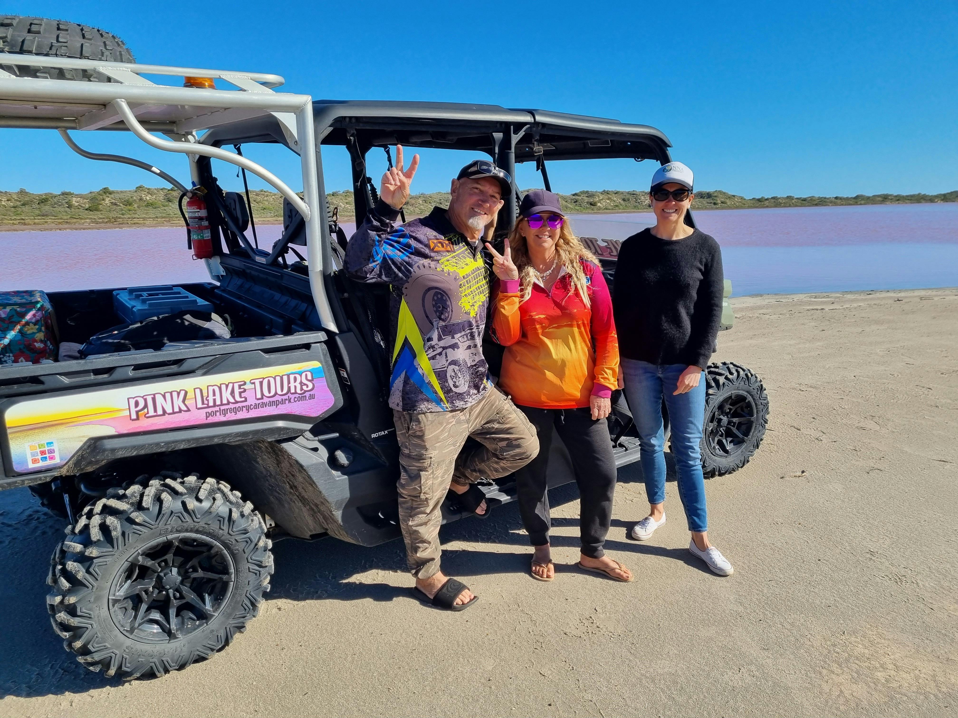3 passengers standing next to the Buggy at the Pink Lake