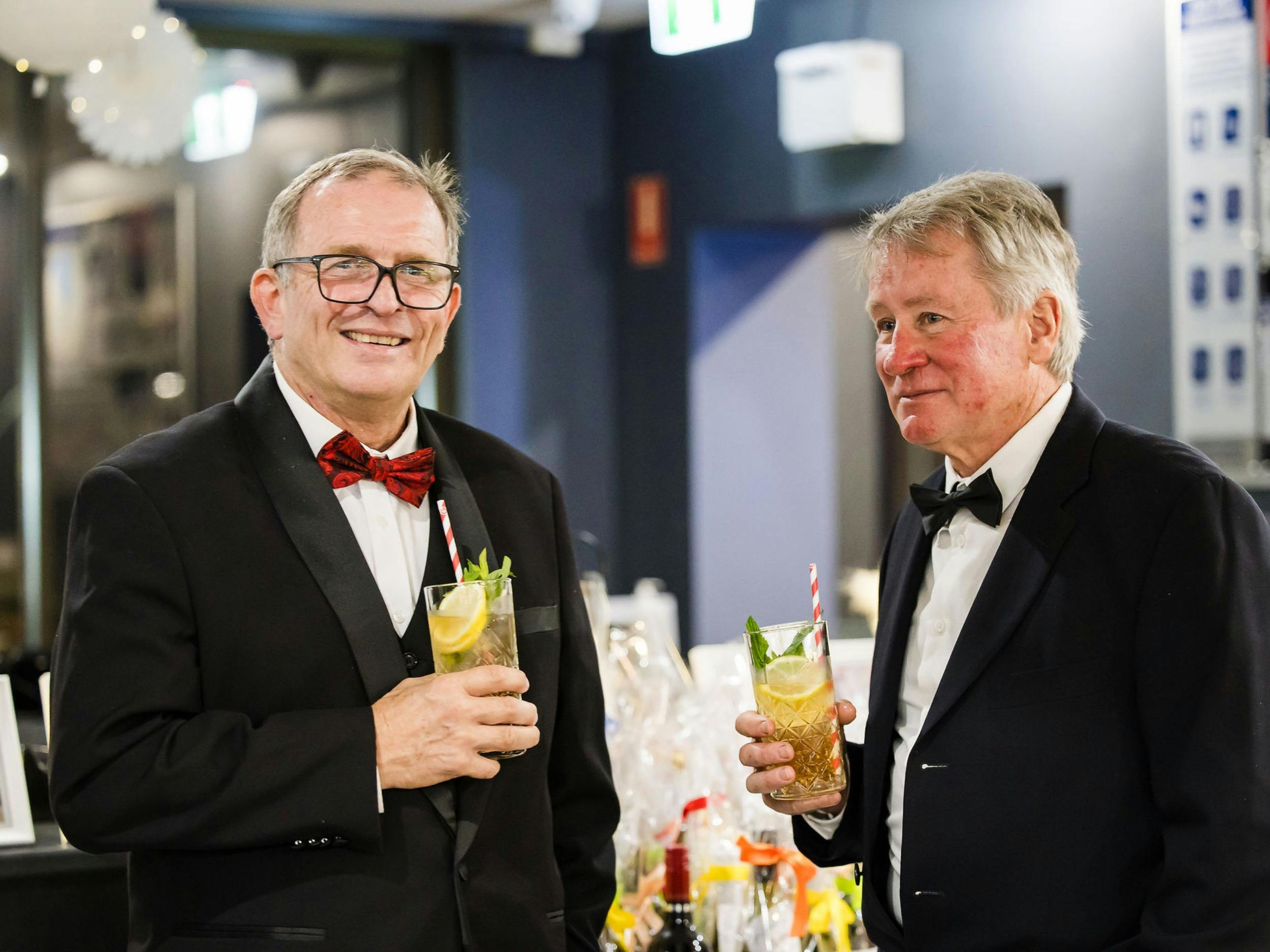 Two men drinking and talking at the Jindabyne Snow Ball