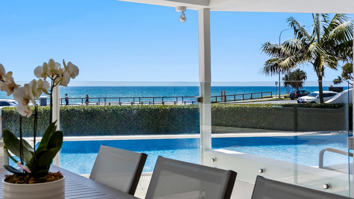 Outdoor dining at holiday home across from Alexandra Headland beach