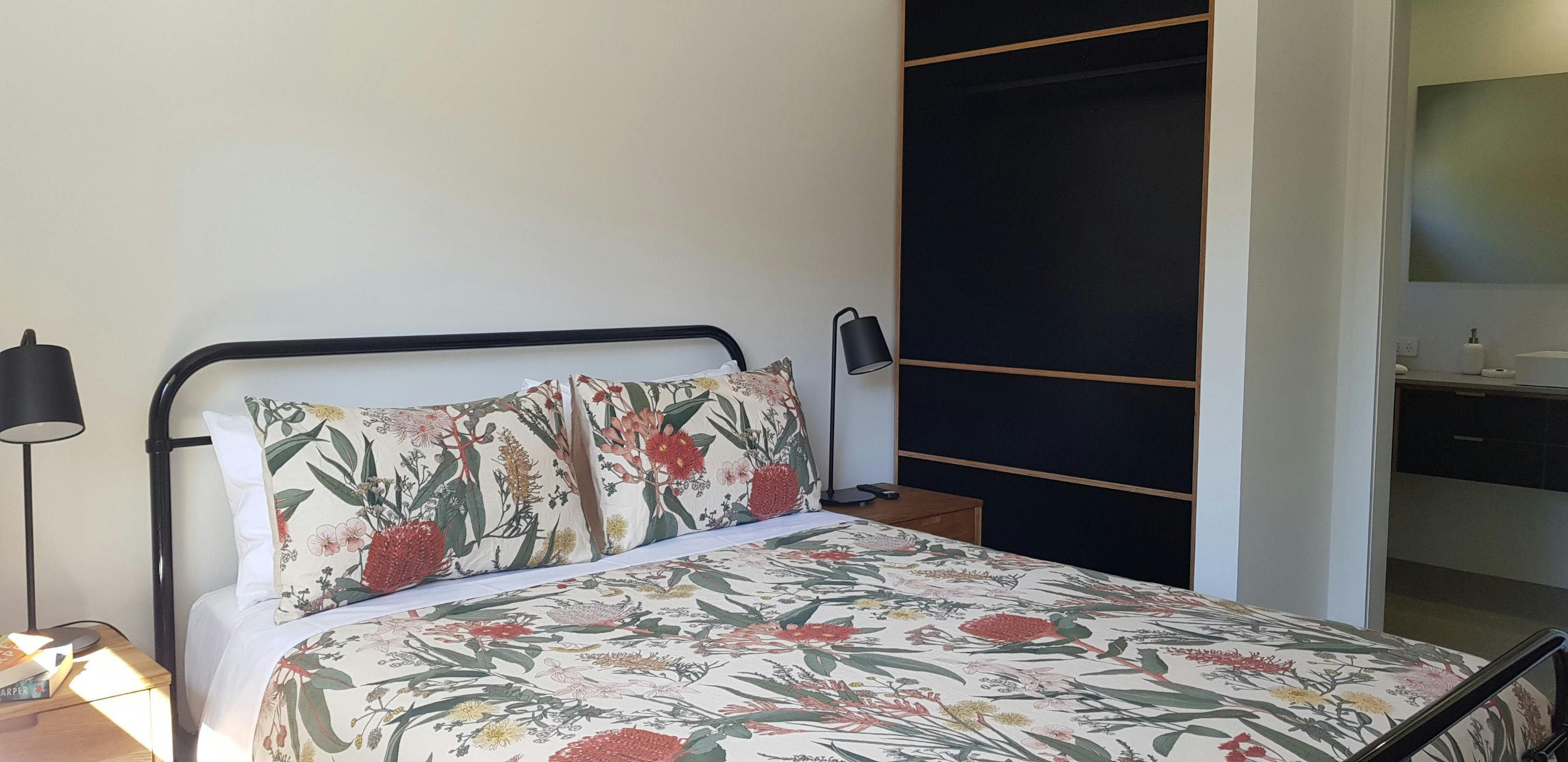 Bedroom with ensuite and two banks of open shelving, for your convenience