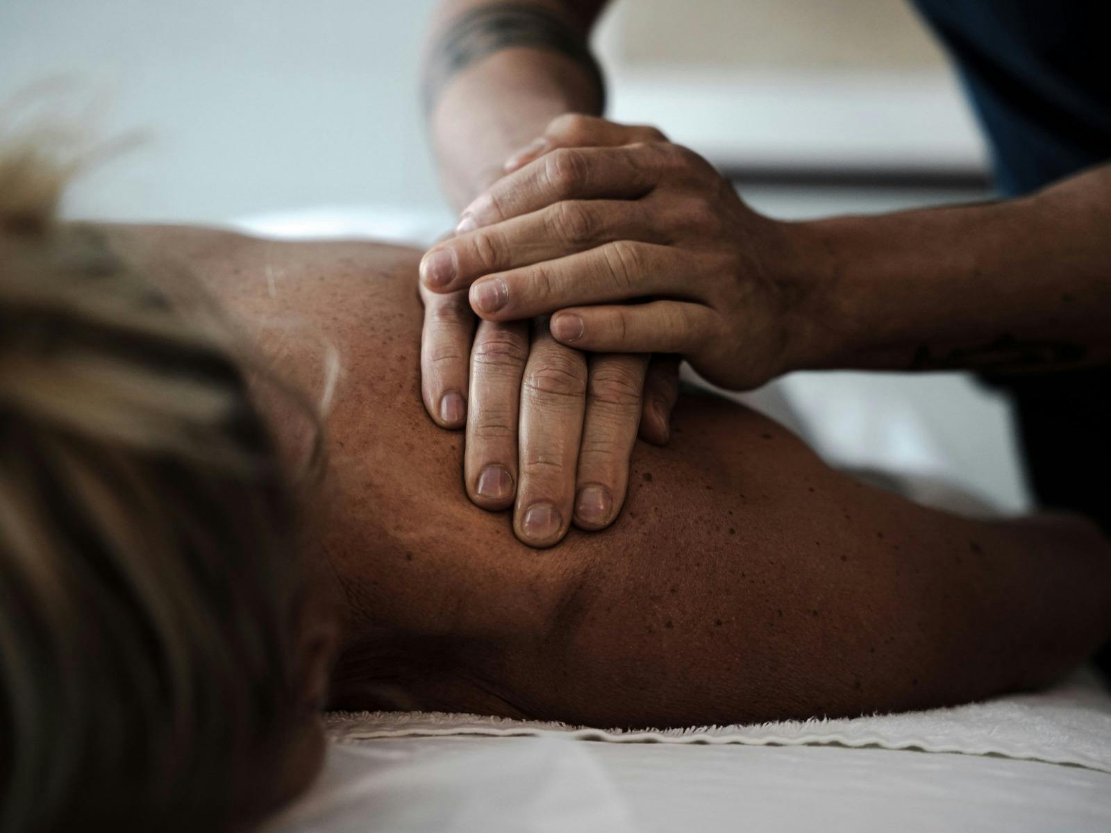 Client receiving a shoulder massage