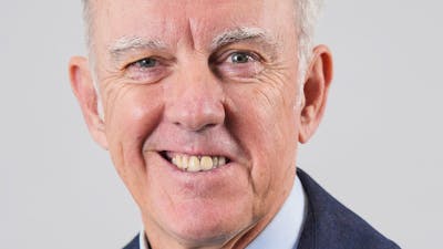A smiling man with gray hair.