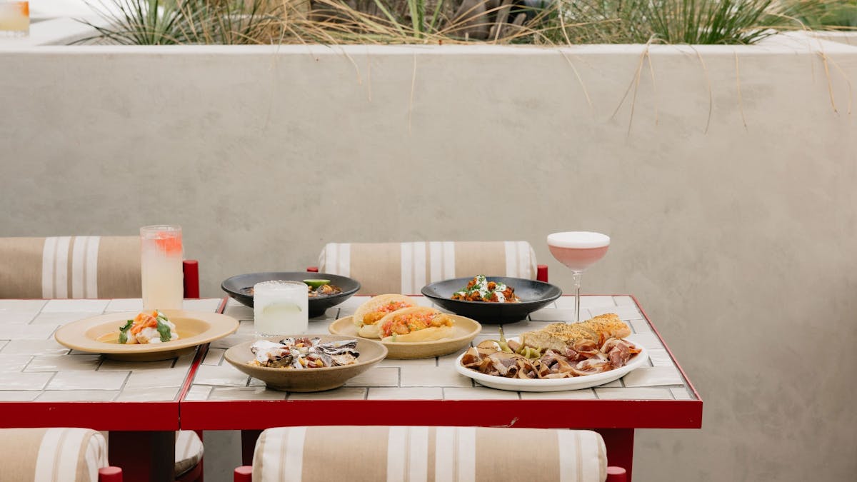 A full spread of food on red and white table