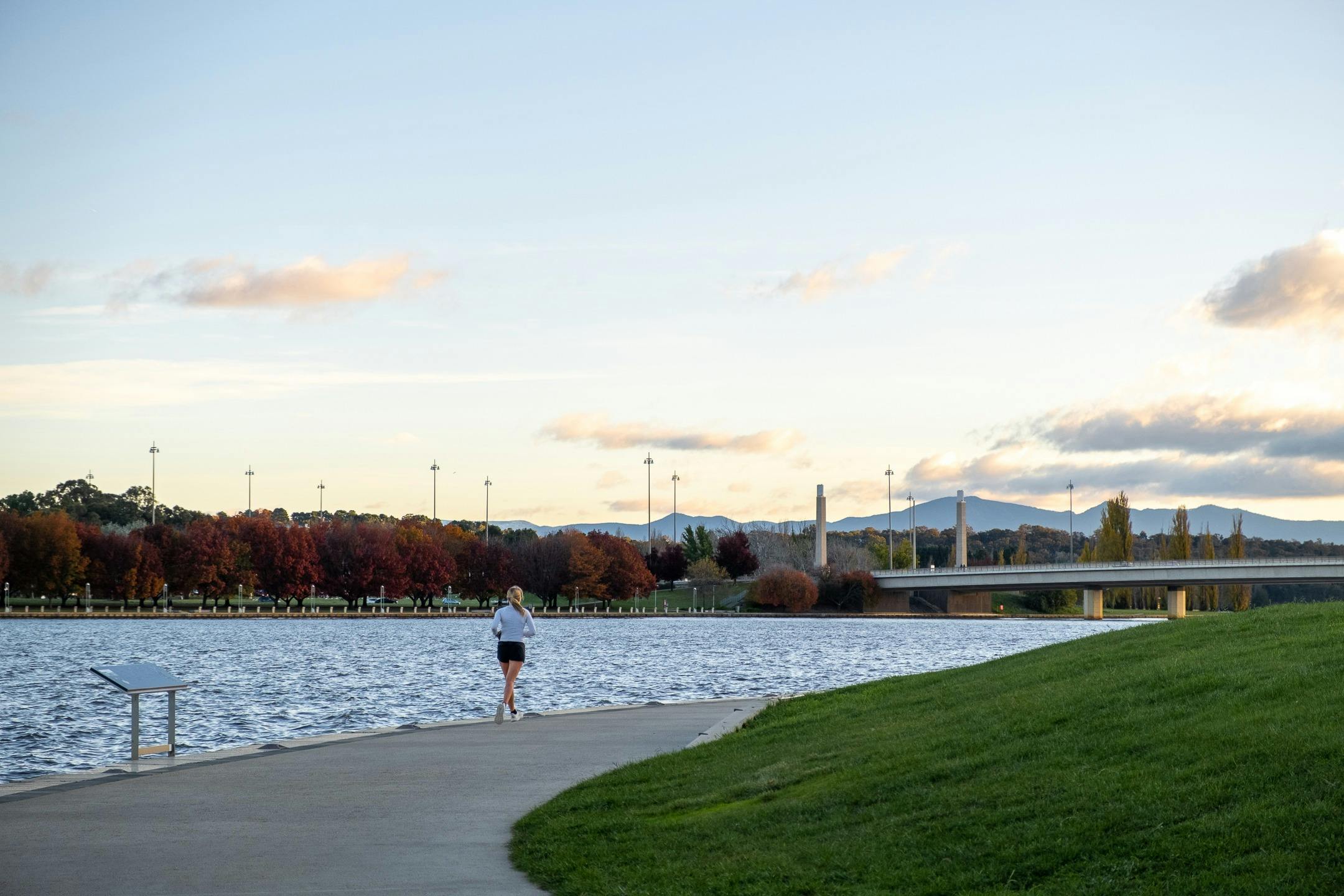 A person running along the lake