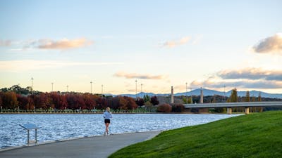 A person running along the lake