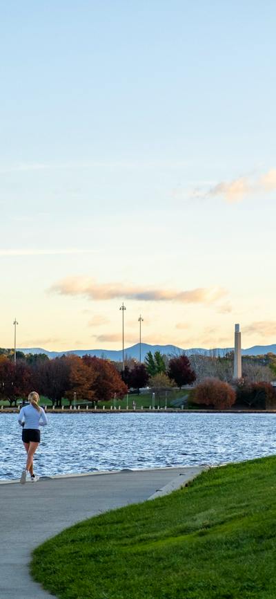 A person running along the lake