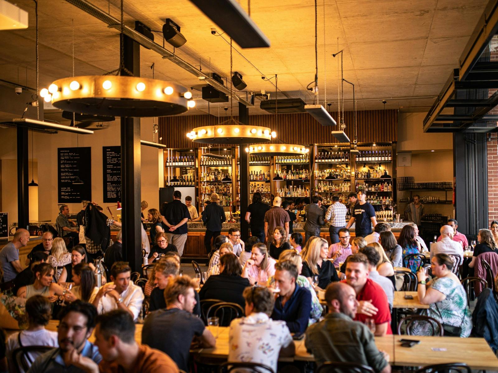 Food hall full of people and dim gold lighting