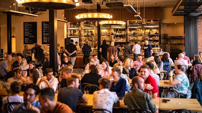 Food hall full of people and dim gold lighting