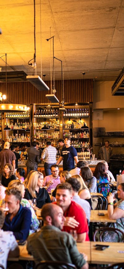 Food hall full of people and dim gold lighting
