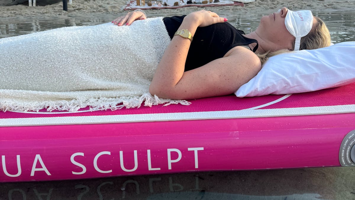 Participant lying on Aqua Sculpt floating boards in a pool at JW Marriott Gold Coast, eyes closed