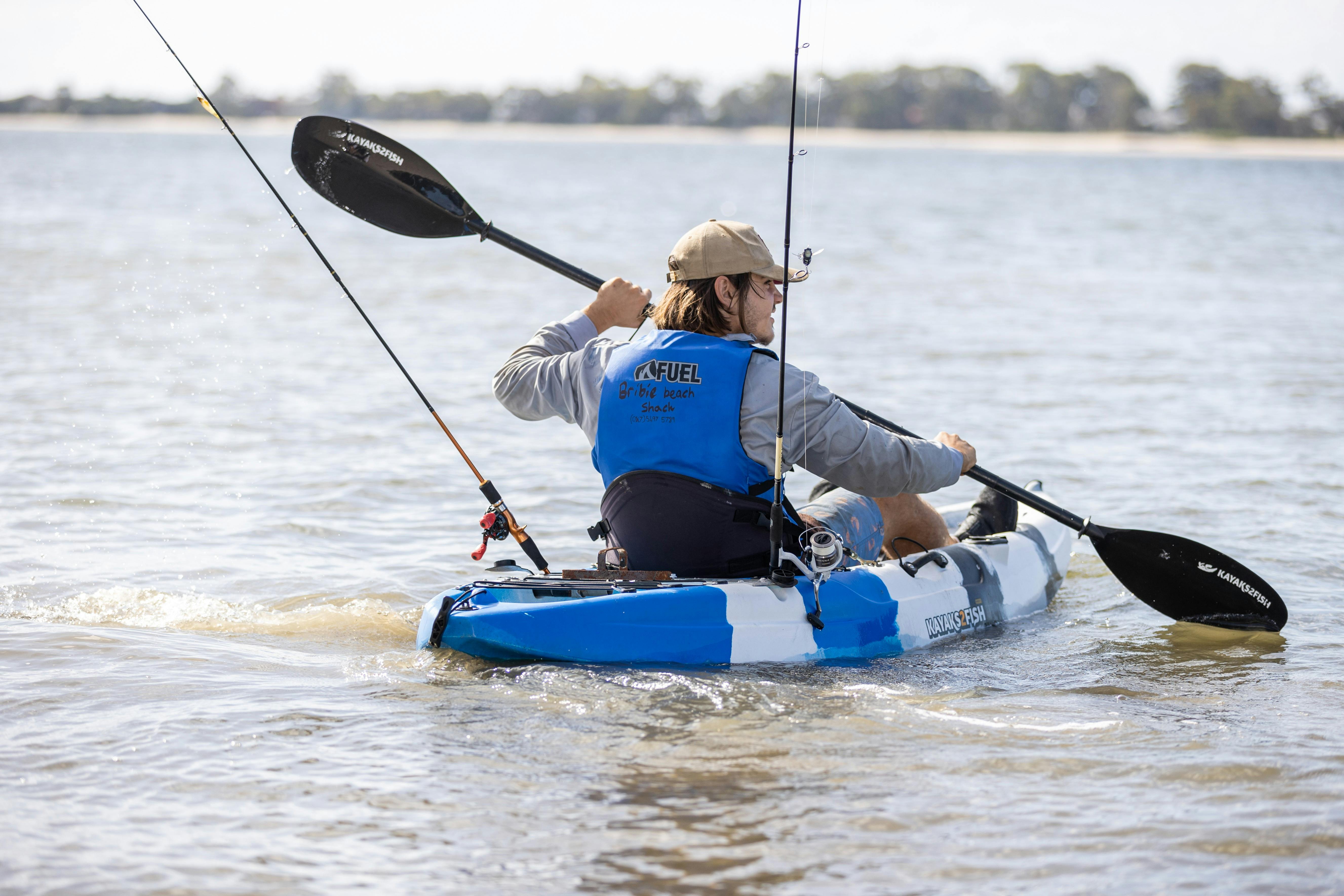 Bribie Beach Shack young man paddling on kayak