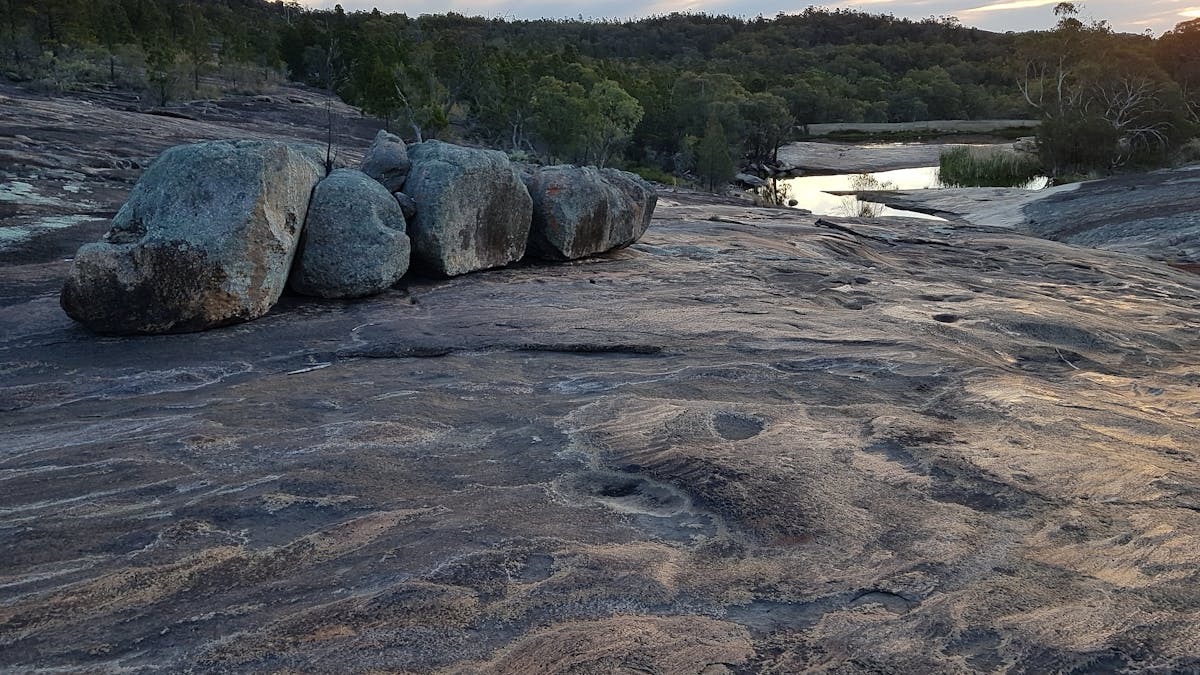 Exposed areas of granite, with large boulders. Water cascades after rain.