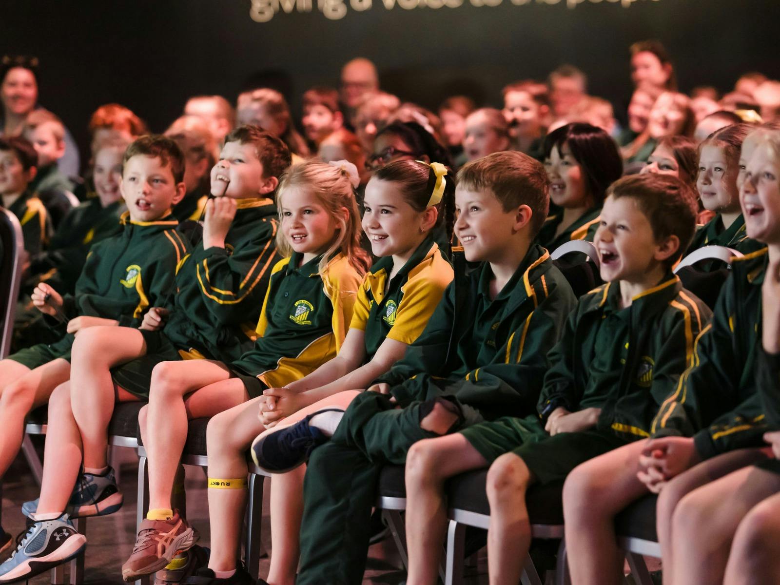 Group of students in school uniform excitedly watching a live show at Write Around the Murray