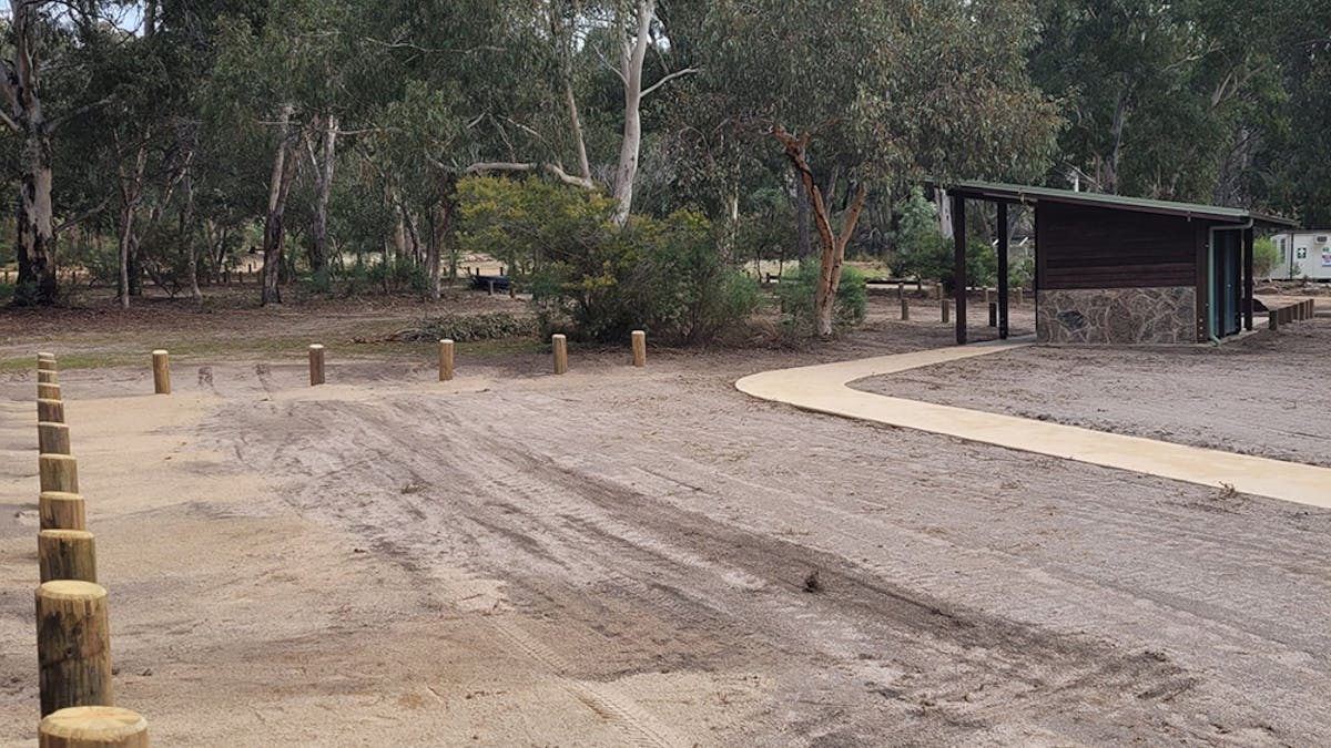 A large and flat camp site situated nearby an accessable visitor facility.