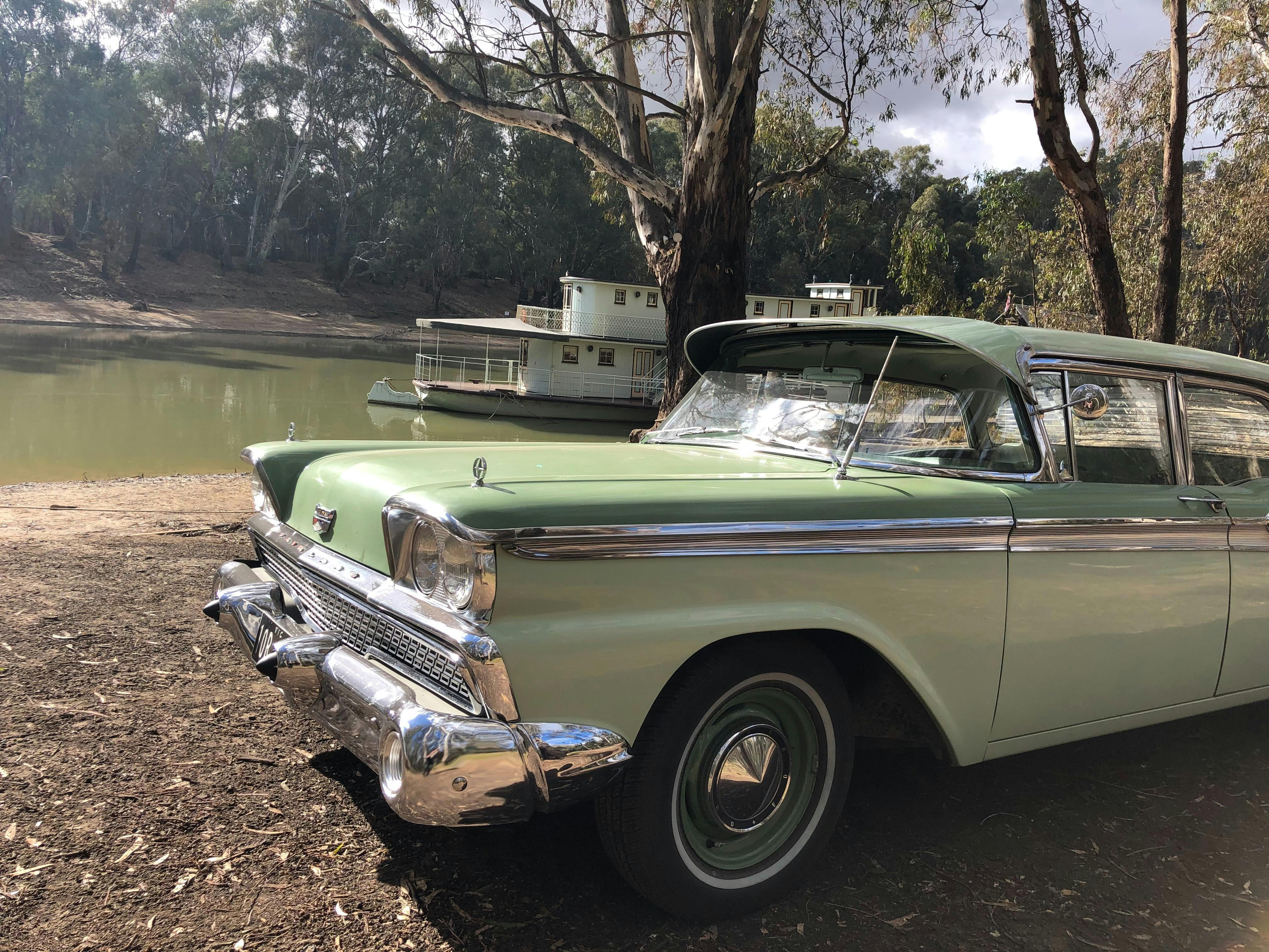 Four door Ford Fairlane two tone green with paddlesteamer